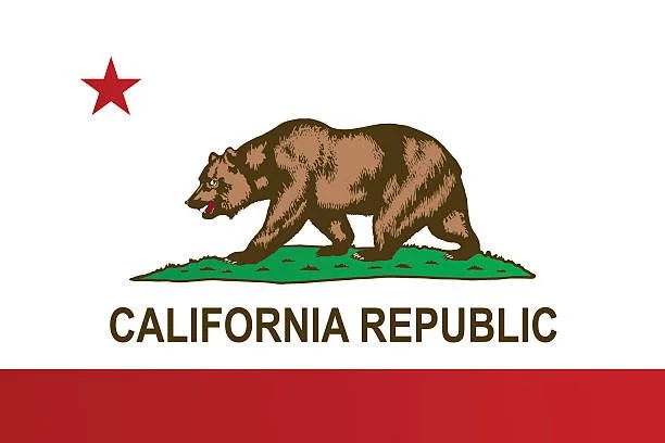 California state flag with a brown bear walking on green grass and a red star above it.