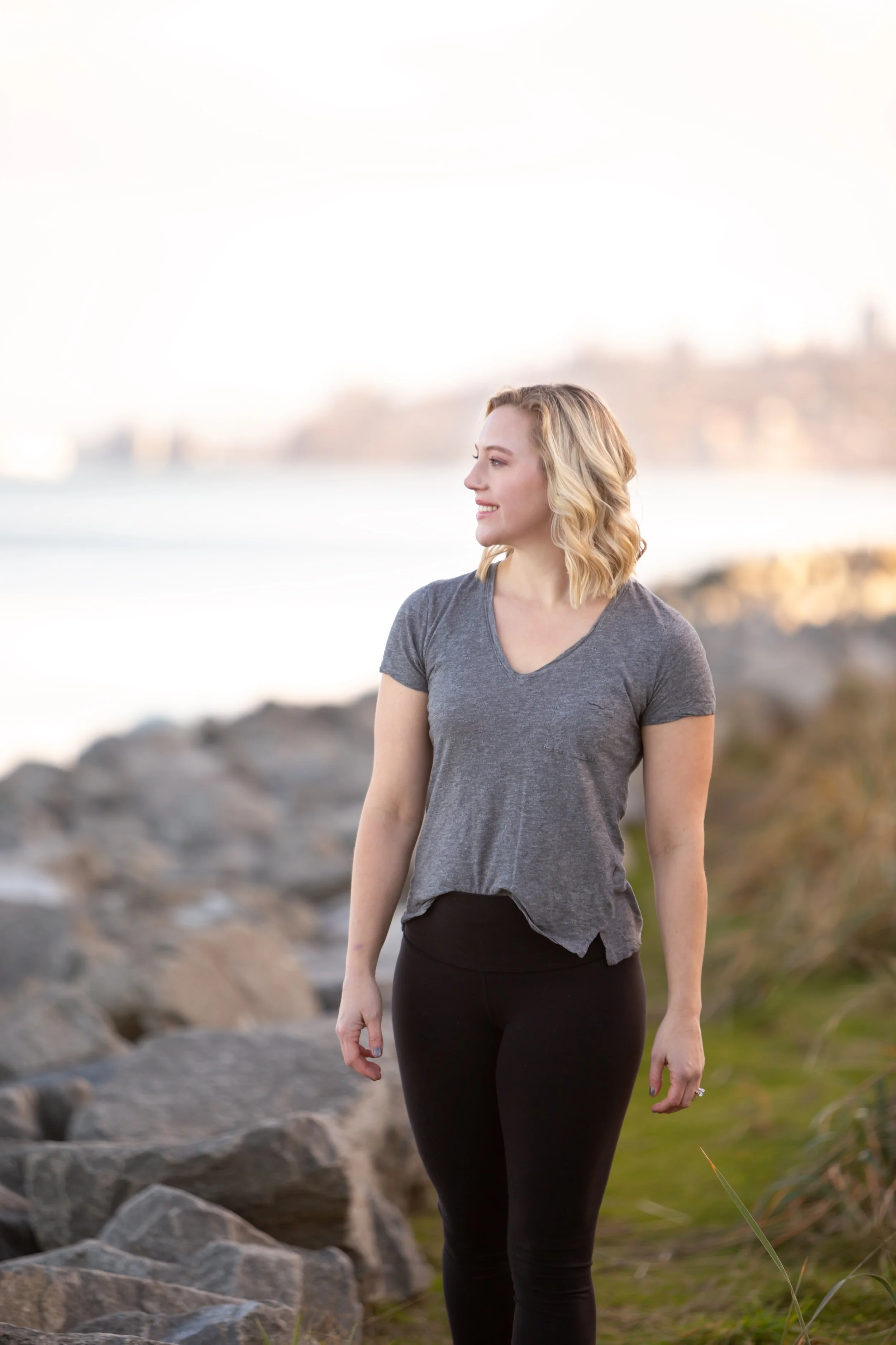 Mary Allison Jensen, LICSW, founder of A Legacy of Healing, standing outdoors near the water looking into the distance — promoting The Change That Changes Everything, a free podcast series on shifting the beliefs that keep women stuck.