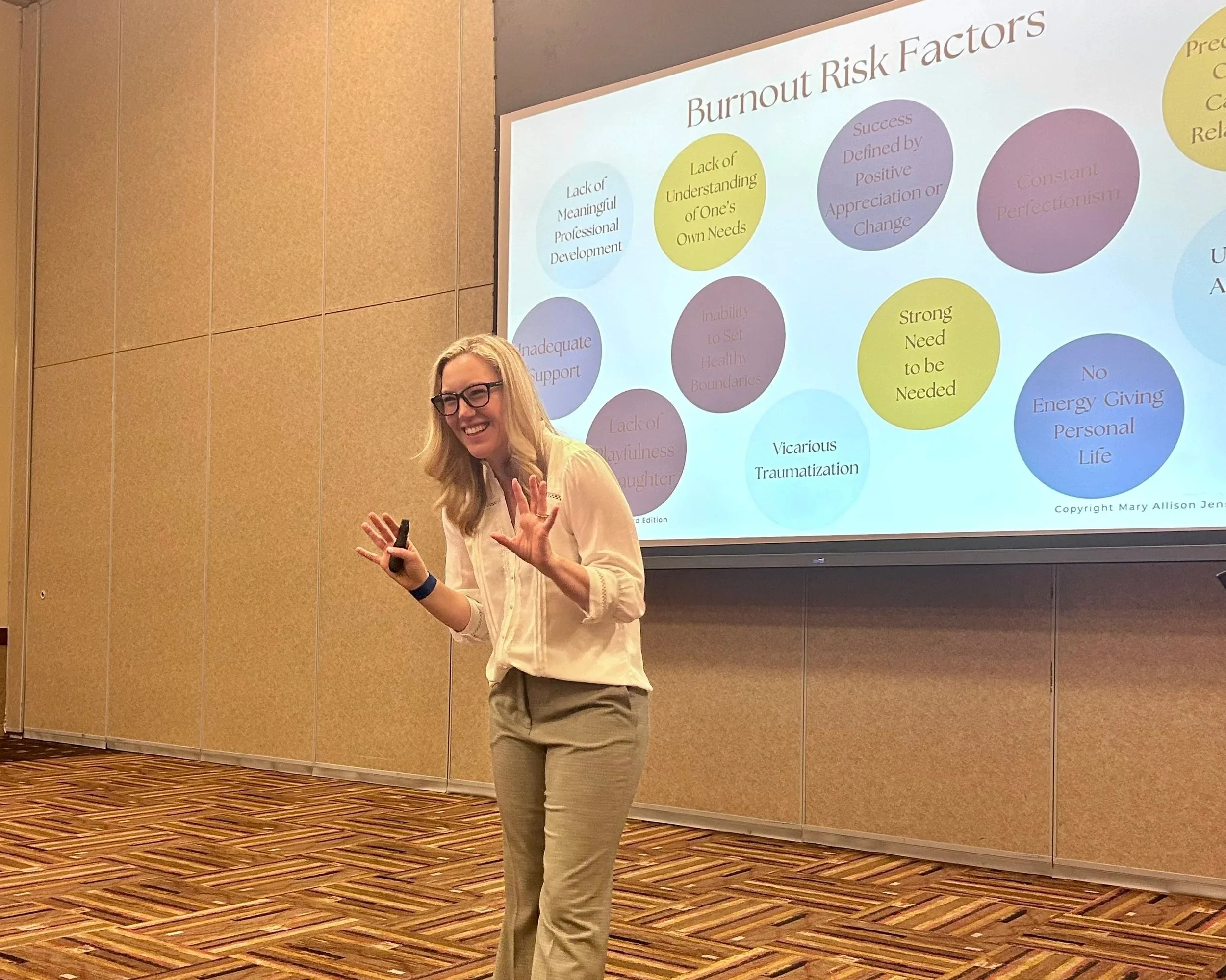 Mary Allison Jensen, LICSW, presenting on burnout risk factors at a conference — licensed clinical social worker and speaker on self-abandonment, burnout, and conscious self-leadership for women.