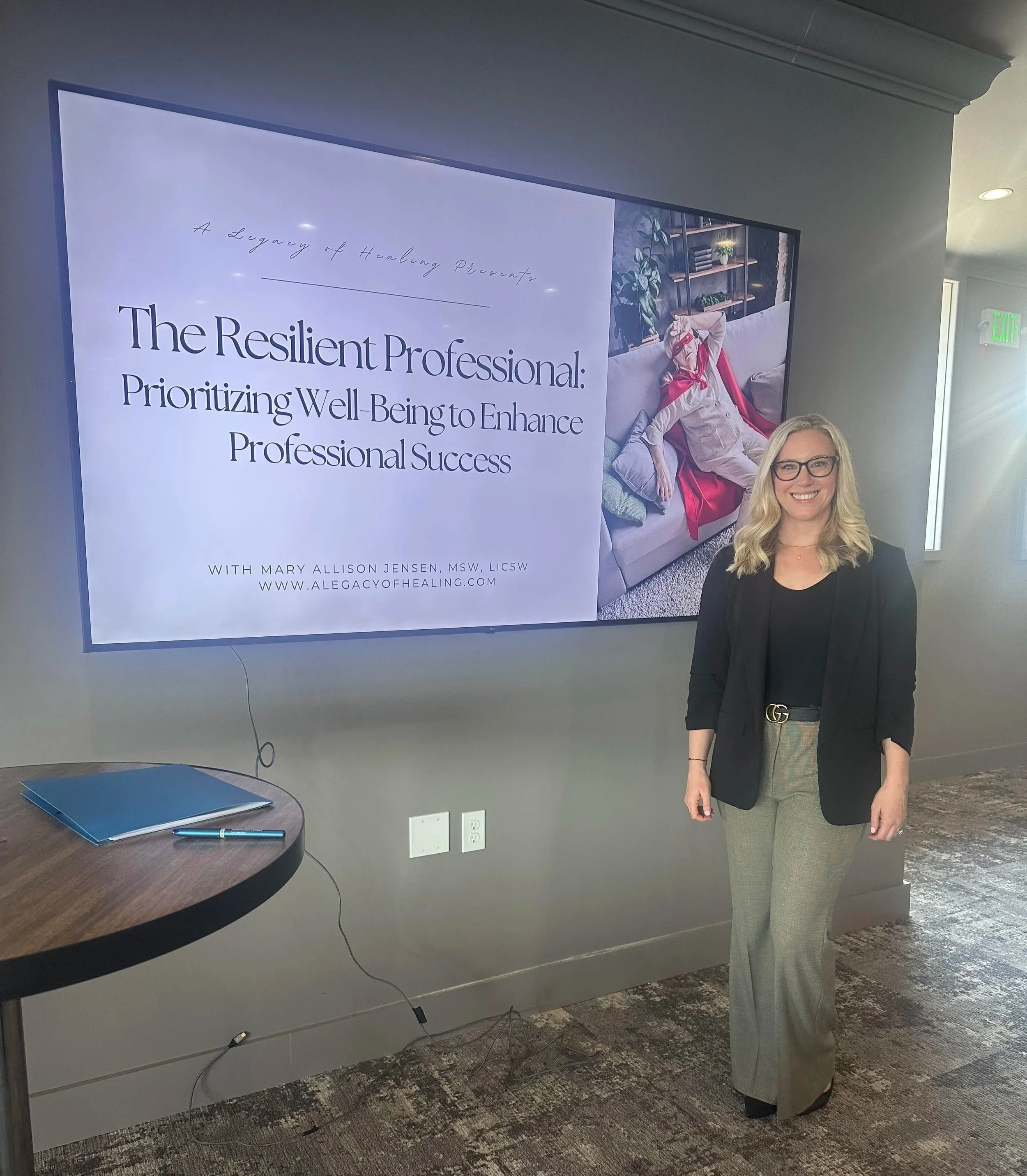 Mary Allison Jensen, LICSW, standing in front of a presentation slide for The Resilient Professional — a keynote on well-being and professional success offered through A Legacy of Healing.