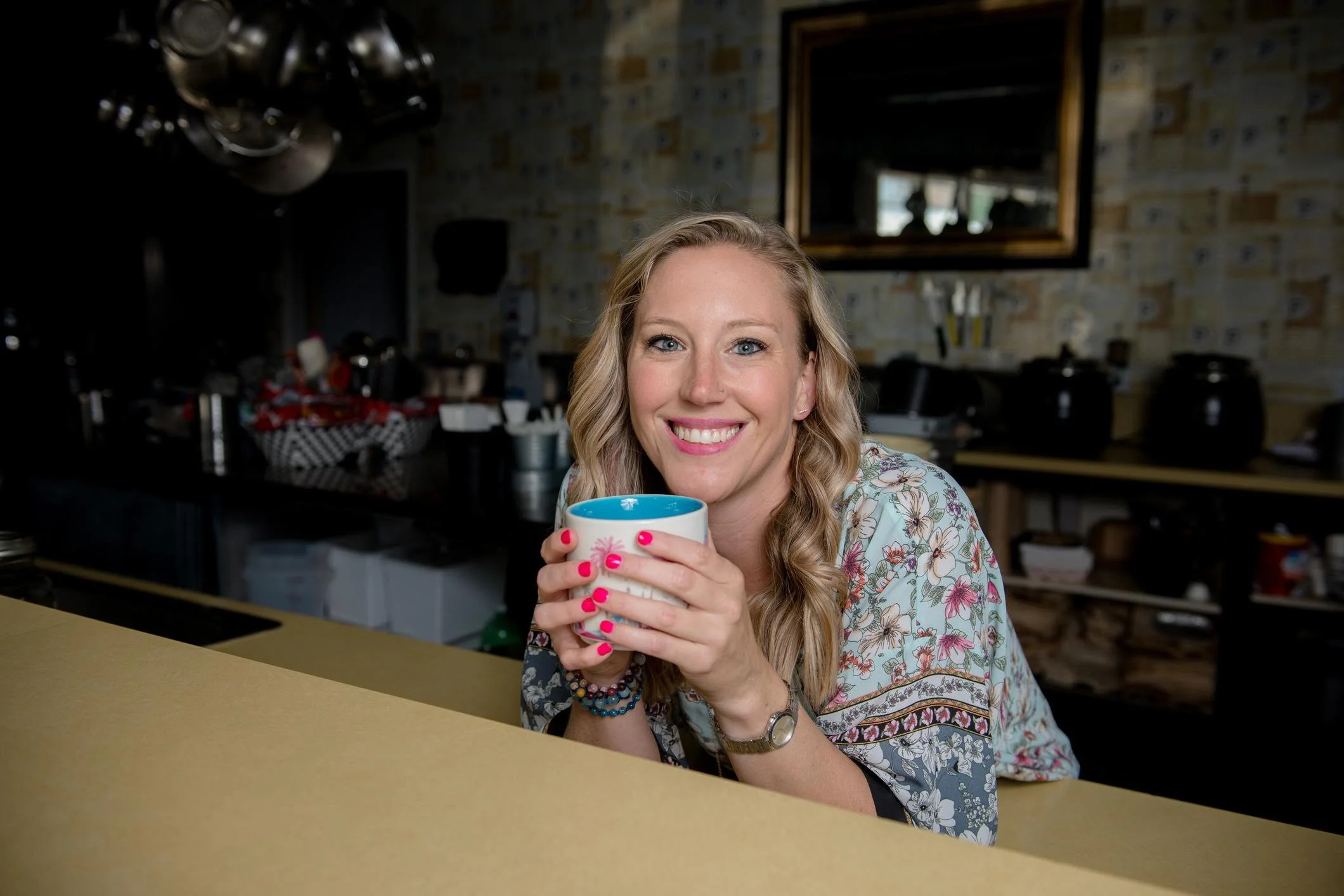 Mary Allison Jensen, LICSW, founder of A Legacy of Healing, smiling warmly while holding a coffee cup — clinician, women's wellness educator, and creator of The Self-Love Lab.