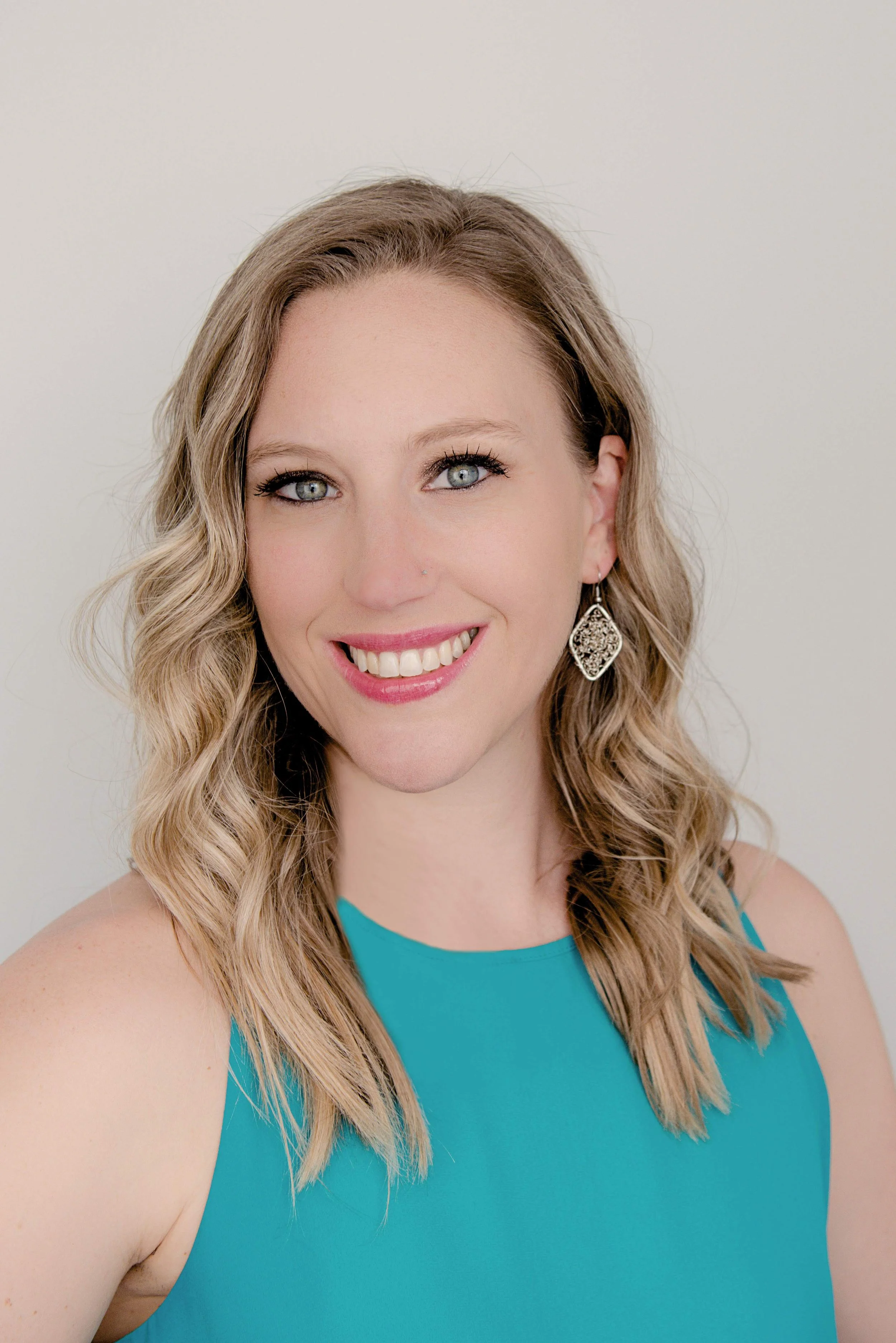 Mary Allison Jensen, LICSW, founder of A Legacy of Healing, smiling in a teal dress — women's wellness educator and creator of The Self-Love Lab.