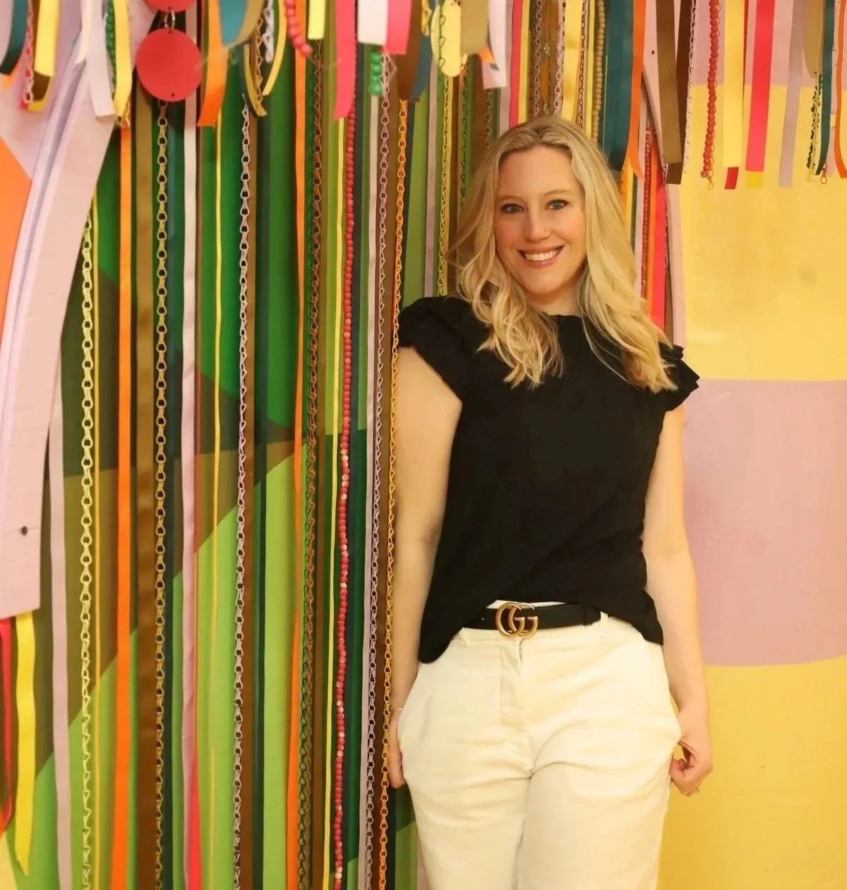 Mary Allison Jensen, LICSW, smiling in front of a colorful ribbon backdrop — founder of A Legacy of Healing and creator of The Self-Love Lab, available for speaking inquiries and collaborations.