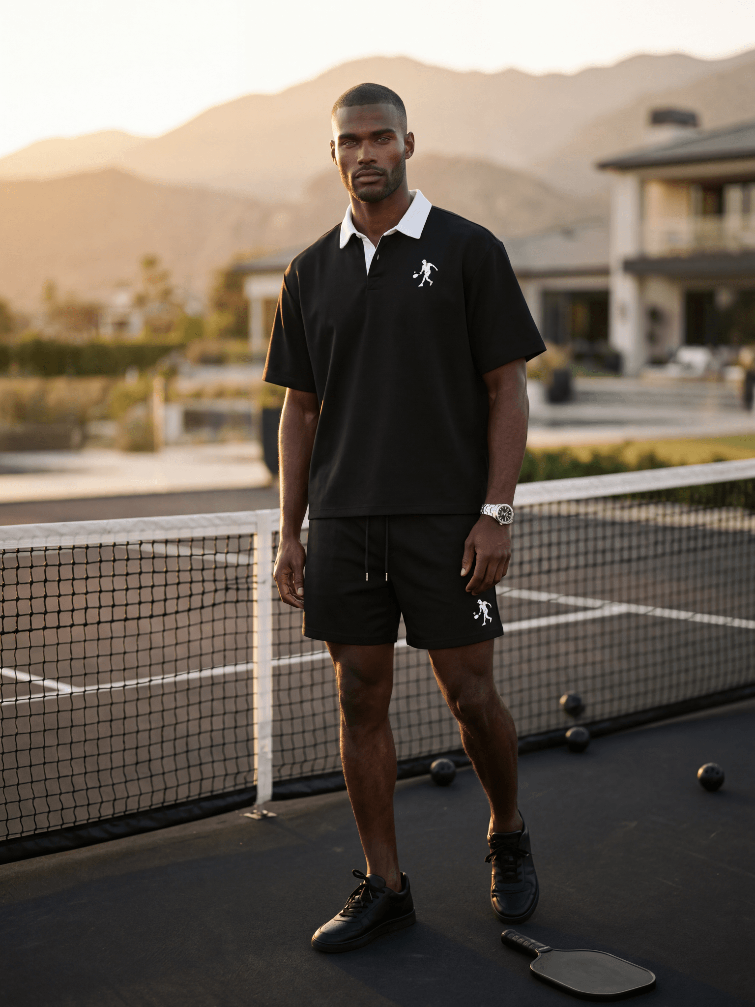 Luxury pickleball outfit men wearing black polo on private court at sunset
