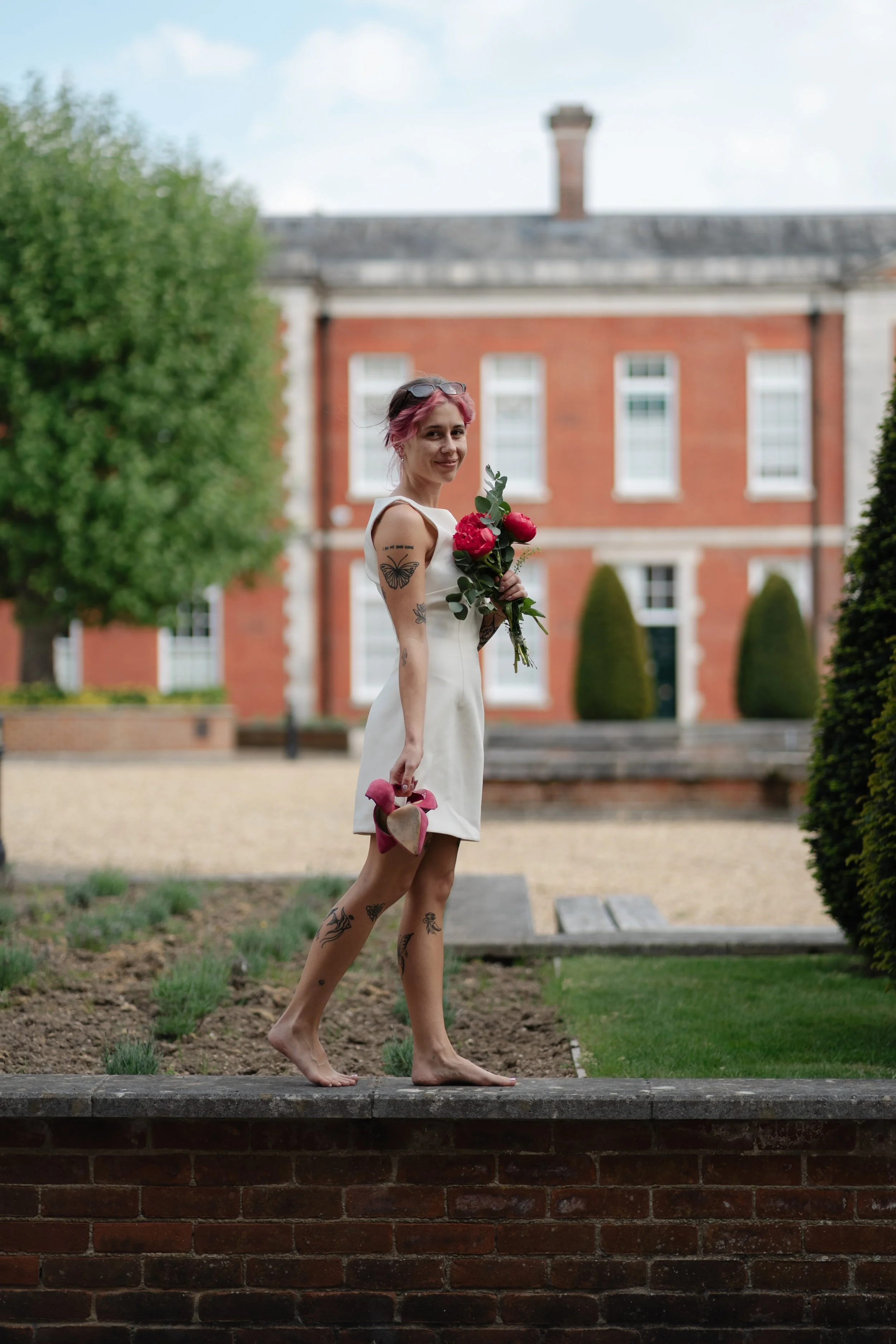 barefoot-bride-garden-wall-candid-portrait.jpg