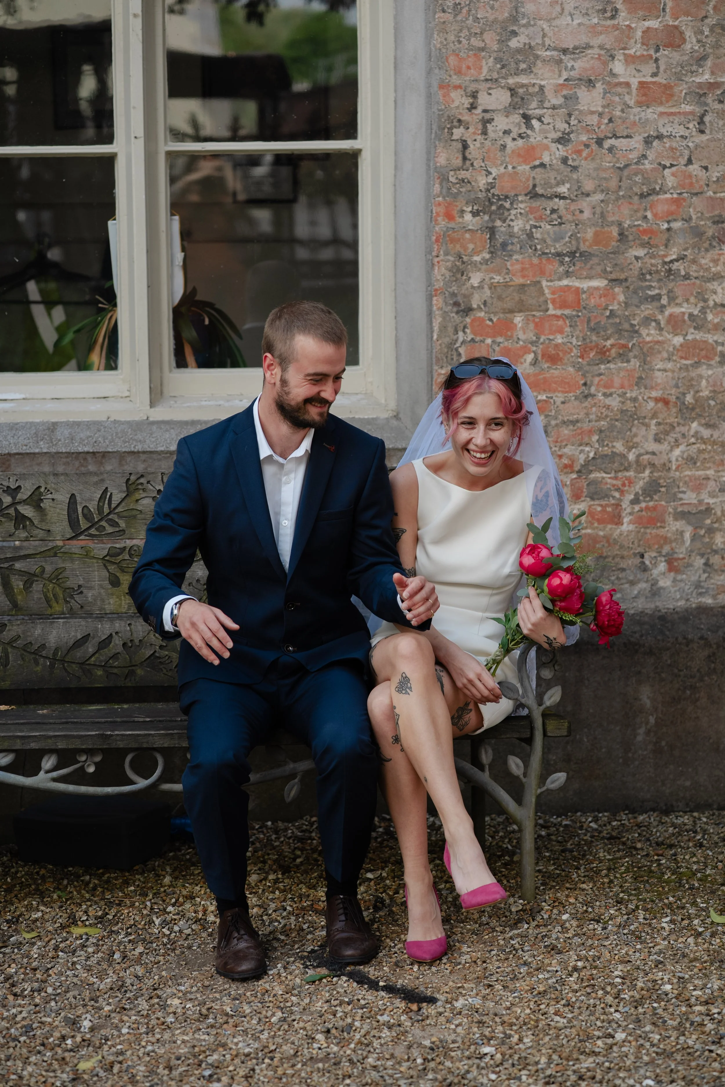 hampshire-wedding-photographer-couple-laughing-garden-bench.jpg
