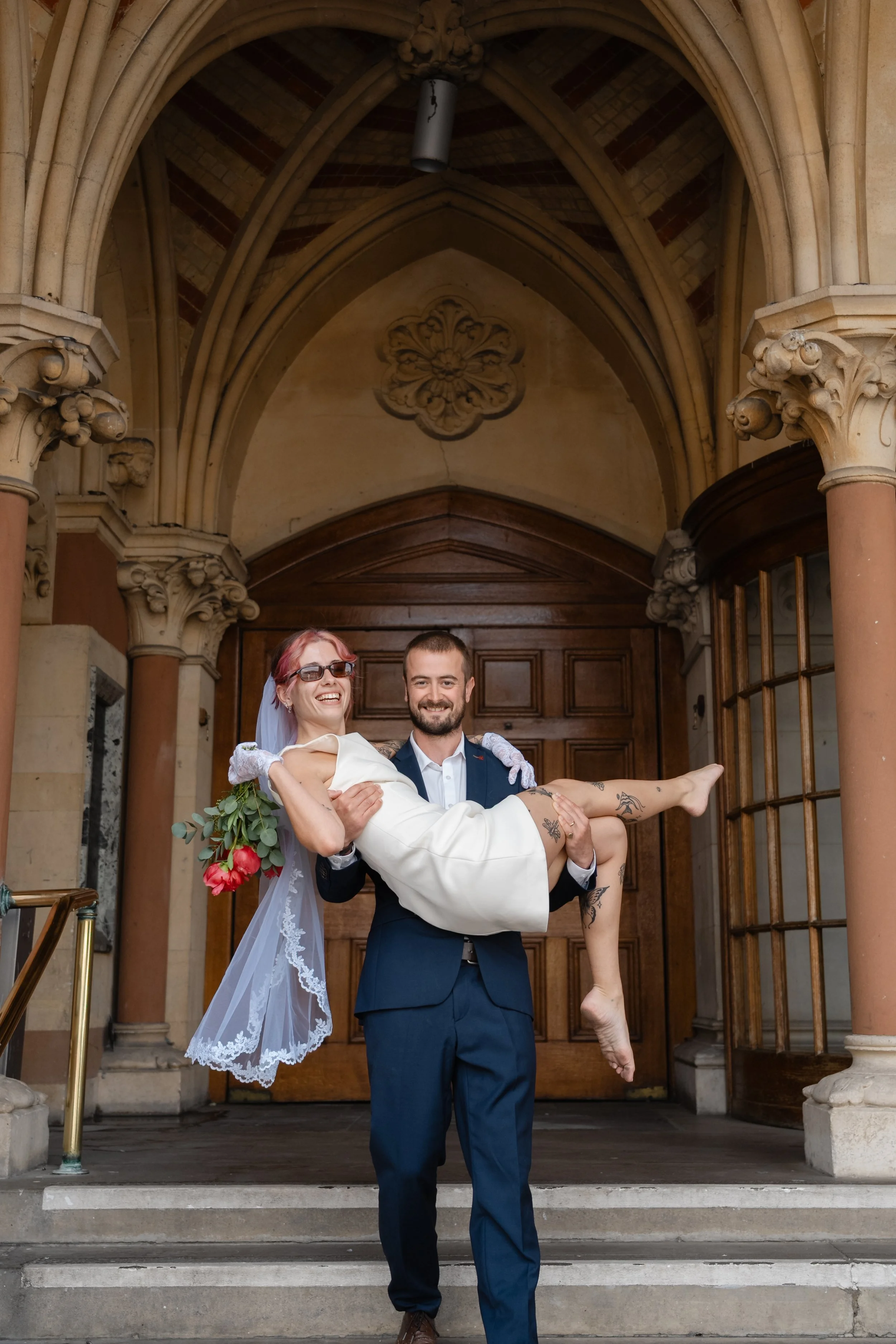 winchester-wedding-photographer-groom-carrying-laughing-bride.jpg