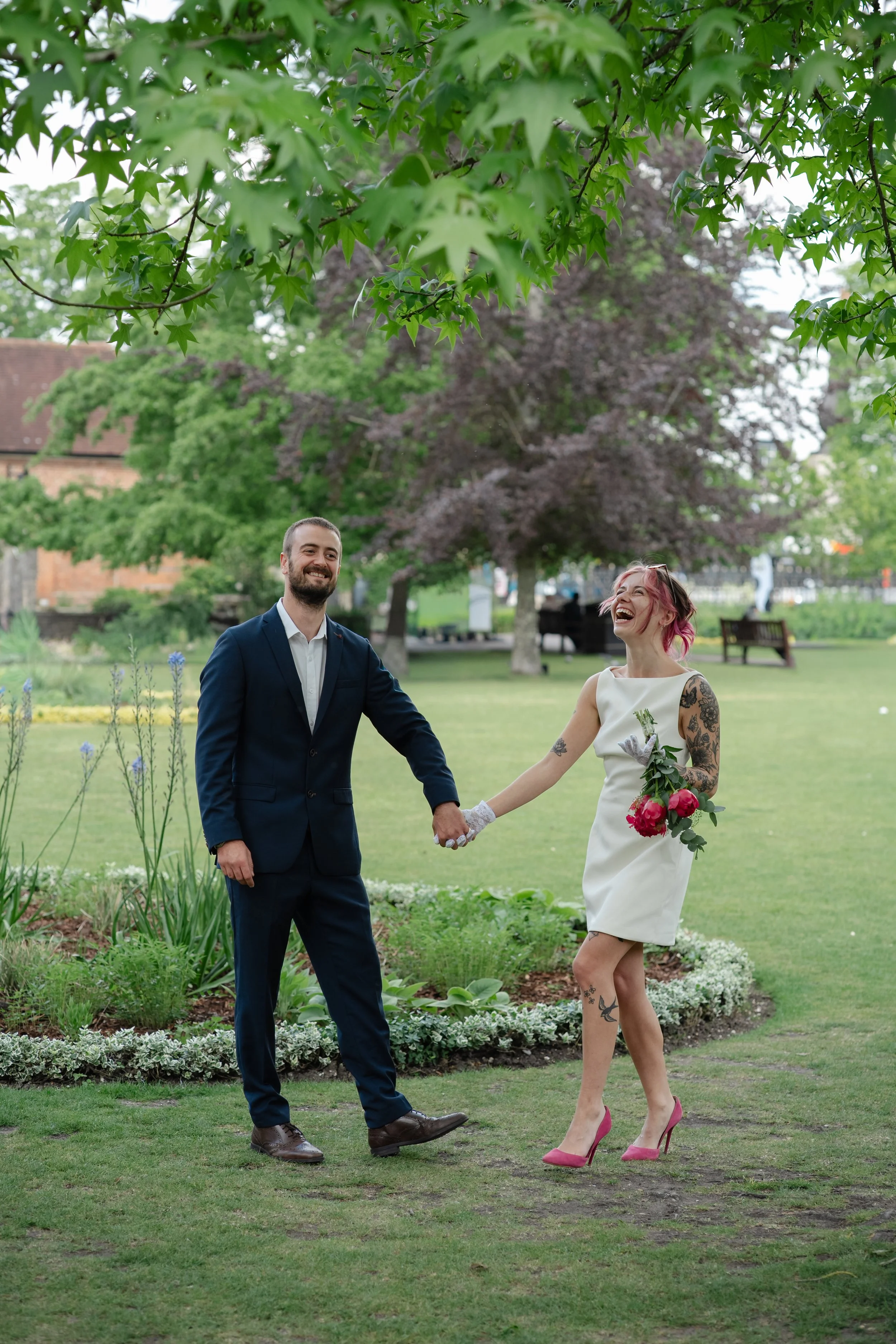 hampshire-wedding-photographer-couple-walking-laughing-garden.jpg