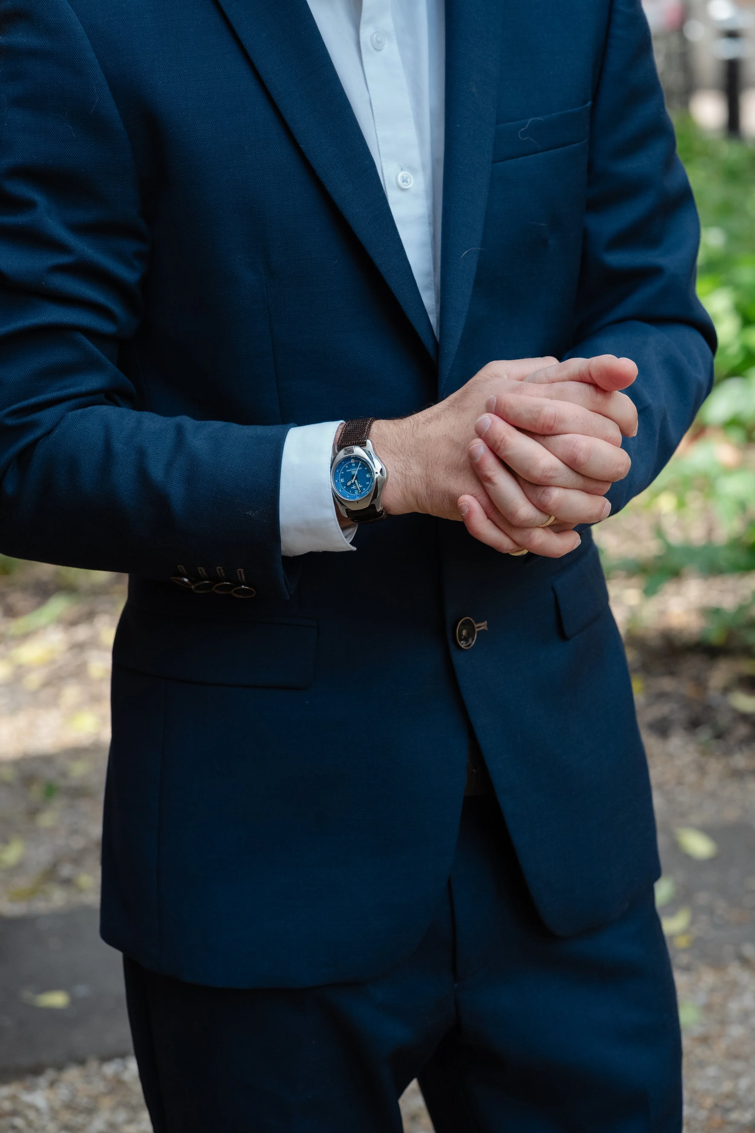 groom-hands-clasped-wedding-ring-watch-detail.jpg