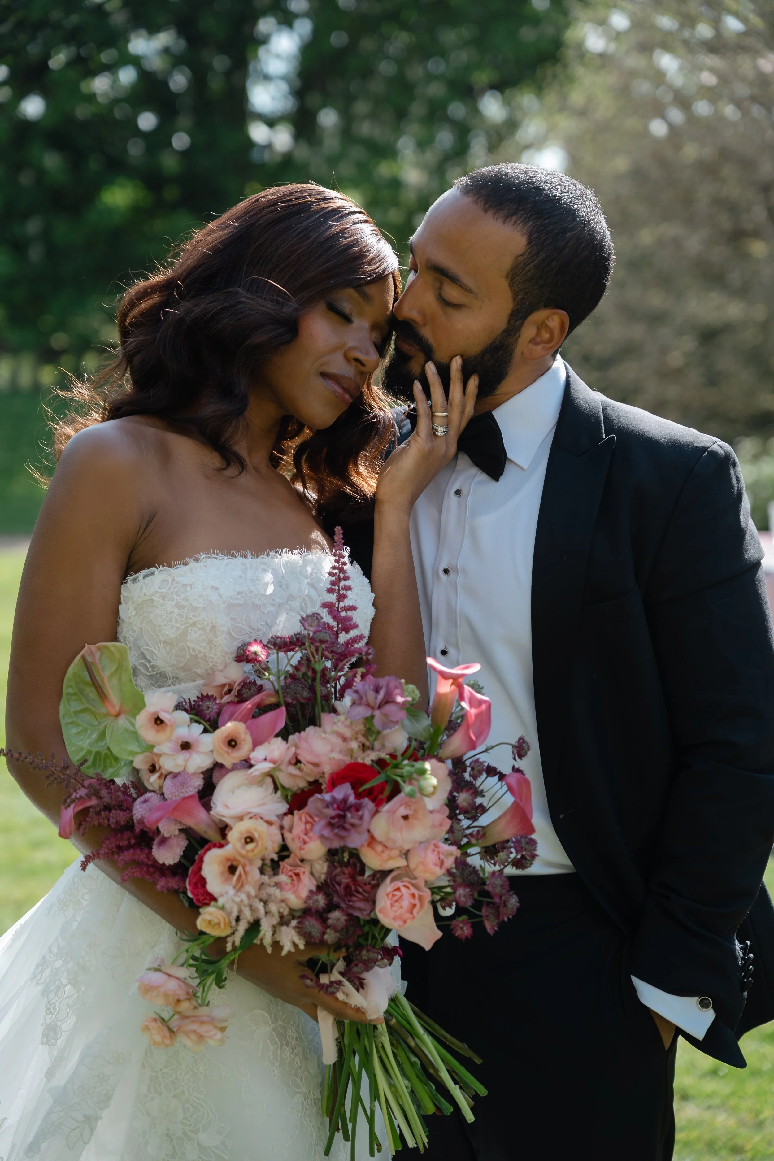 bride and groom with a bouquet of pink flowers