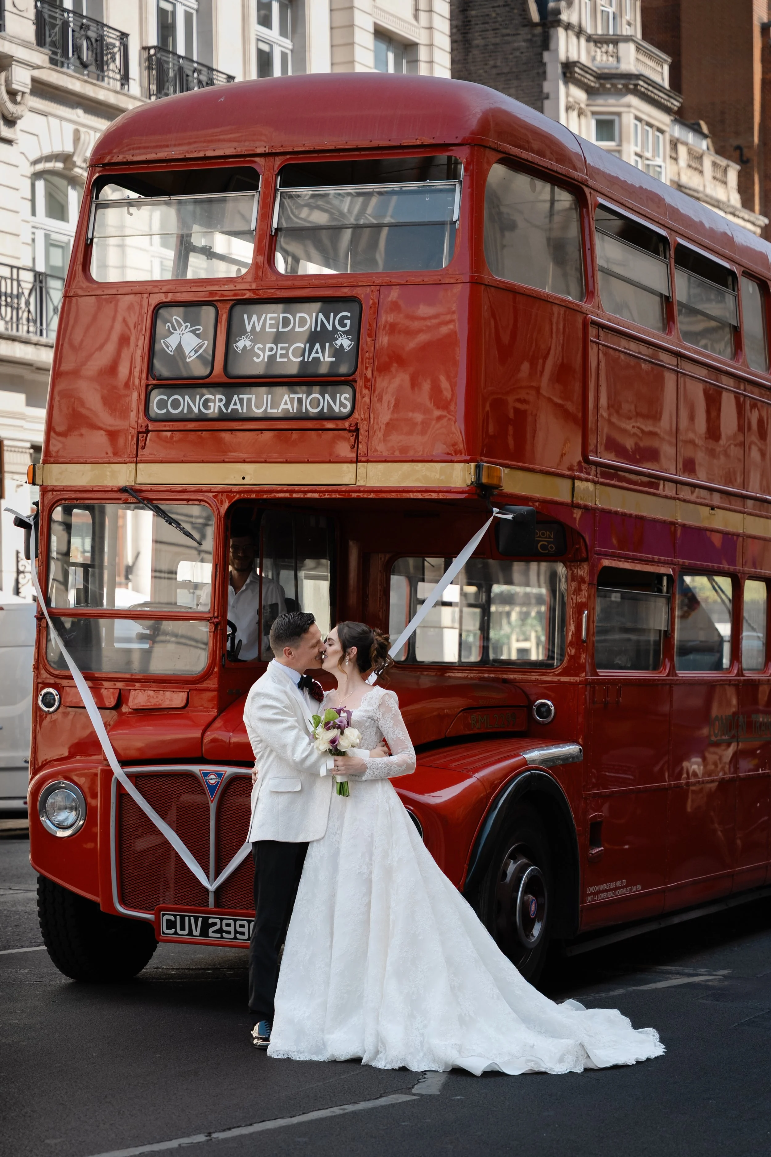bride and groom in front of London bus