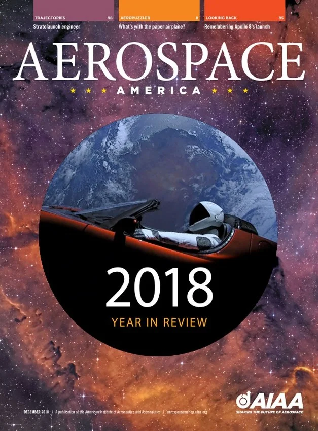 Cover of Aerospace America magazine's December 2018 issue featuring a space-themed background with stars and a nebula, an Earth view, and a fighter jet cockpit in the foreground. The text highlights the magazine's 2018 year in review.