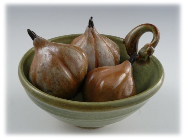 A ceramic bowl filled with four dried pufferfish gouramis.