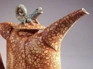 An elephant-shaped teapot with a bird sitting on its top