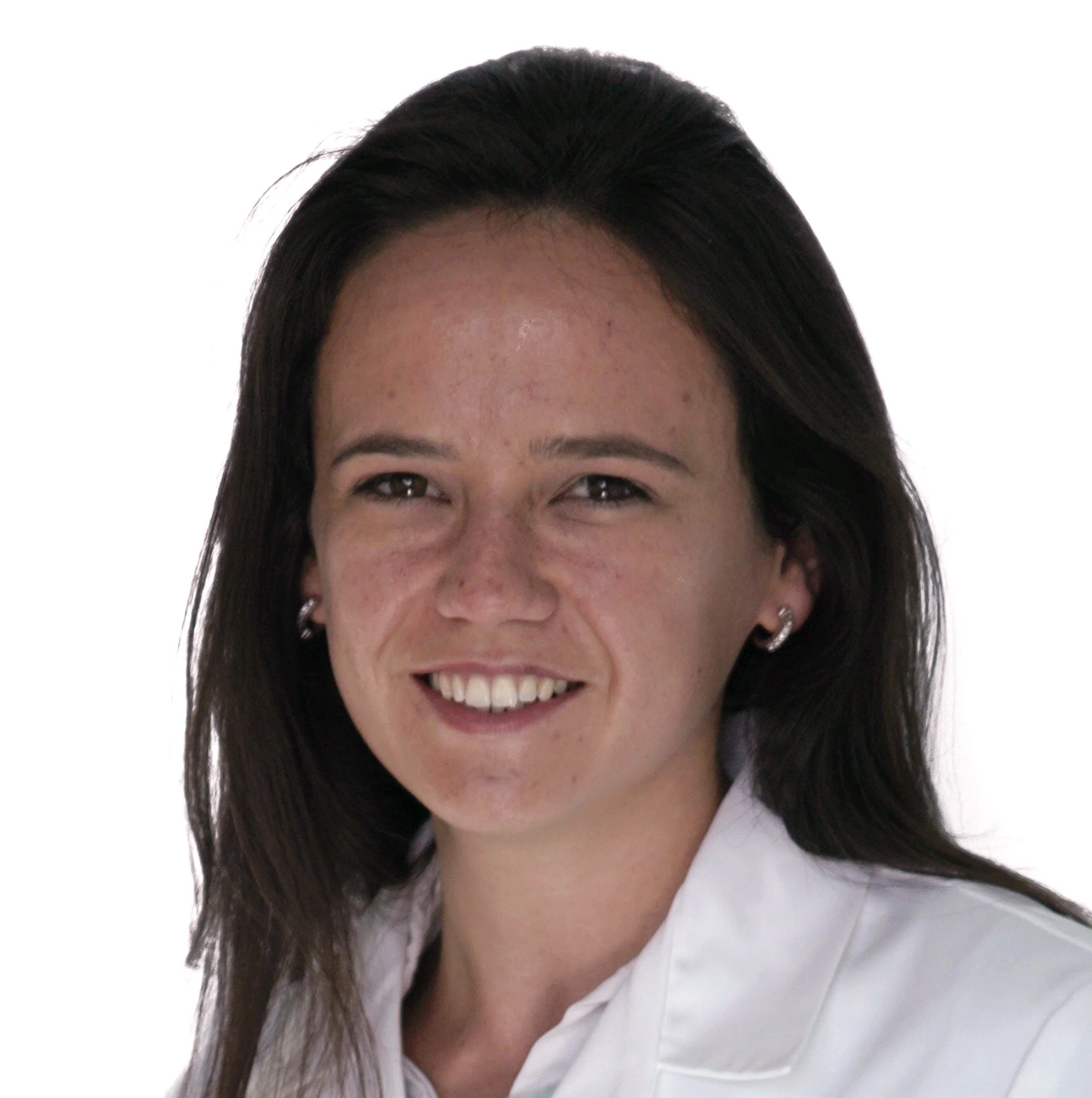 Close-up of a smiling woman with long dark hair wearing a white shirt.