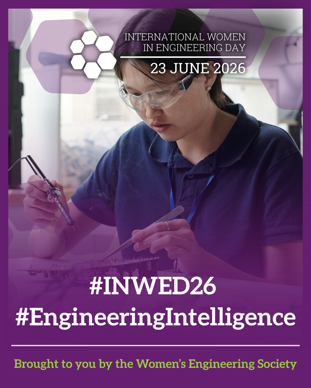 A woman wearing safety goggles working with electronic equipment in a laboratory setting, promoting International Women in Engineering Day 2026.
