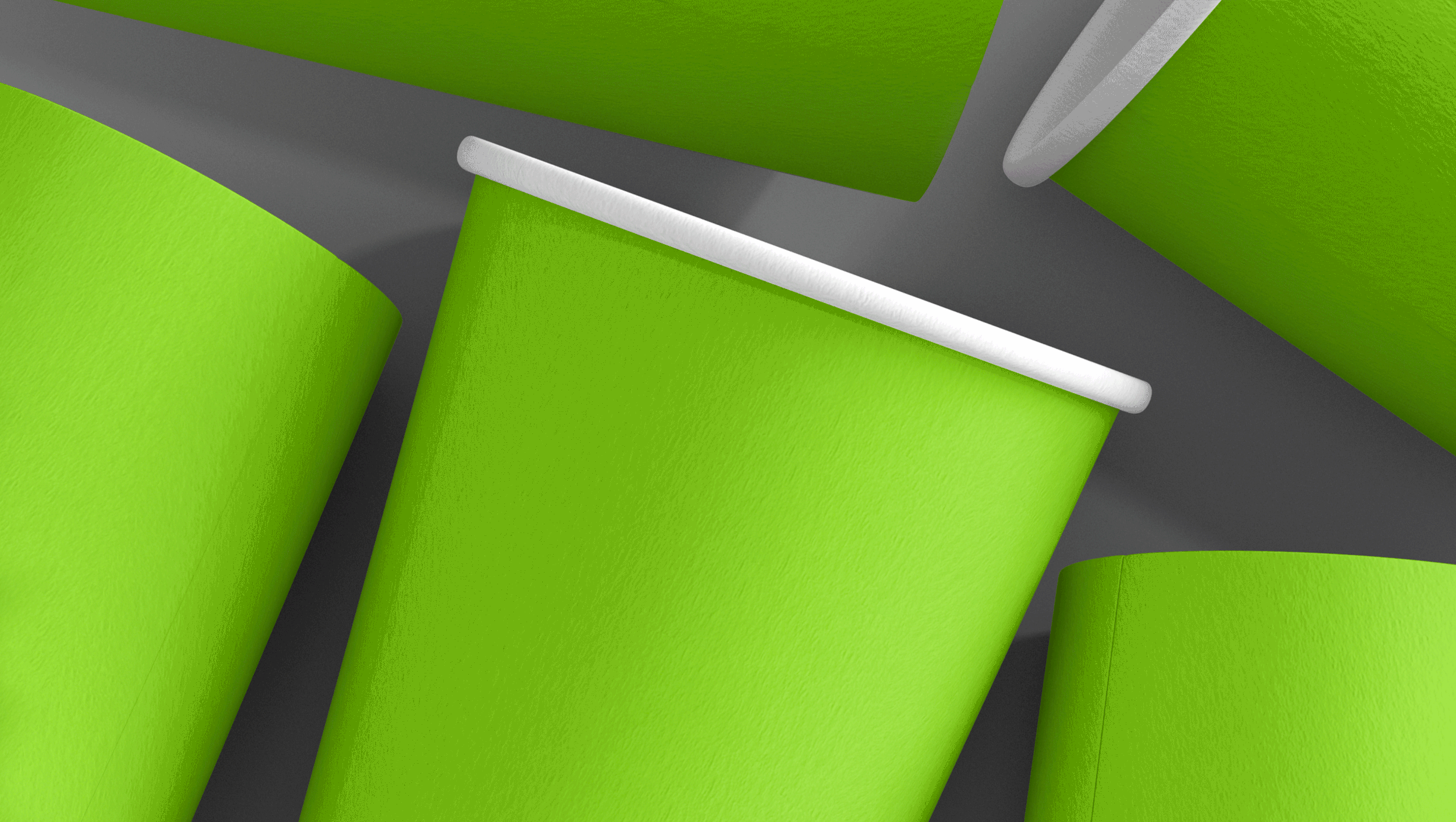 Close-up of several green paper cups with white rims, overlapping each other on a gray surface.