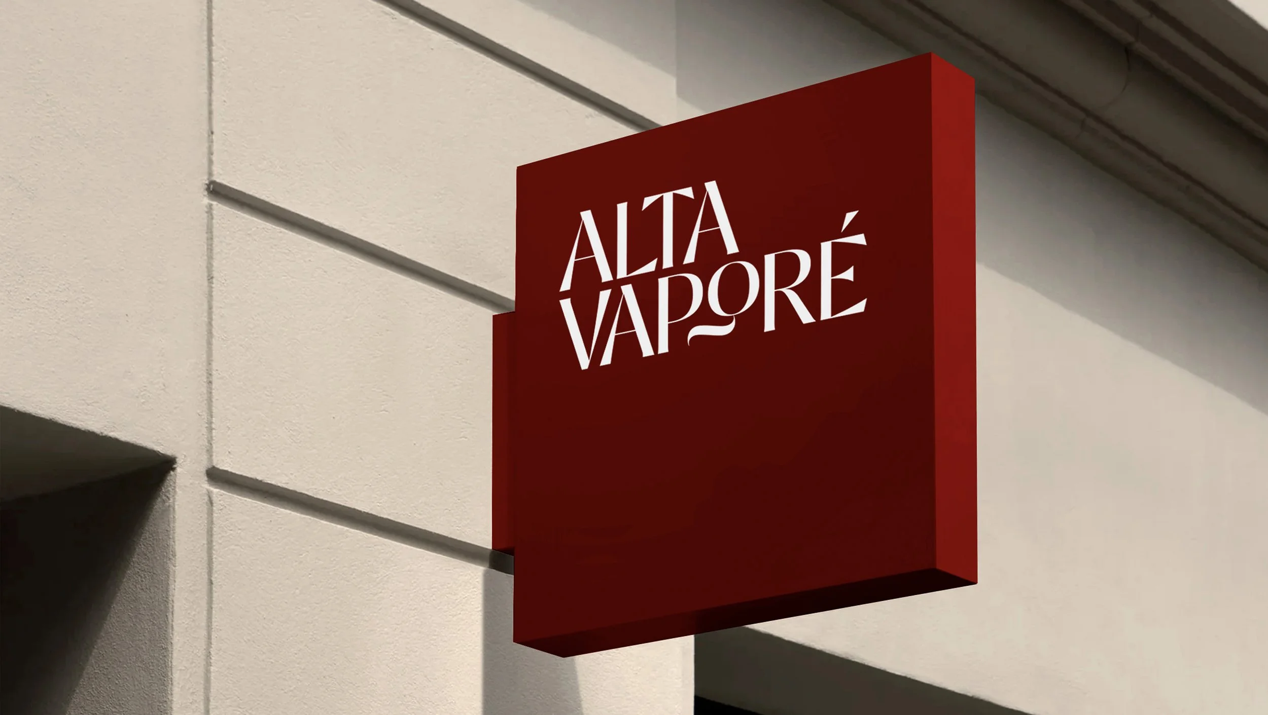 Red 3D signboard with white text reading "ALTA VAPOR" mounted on a beige wall.