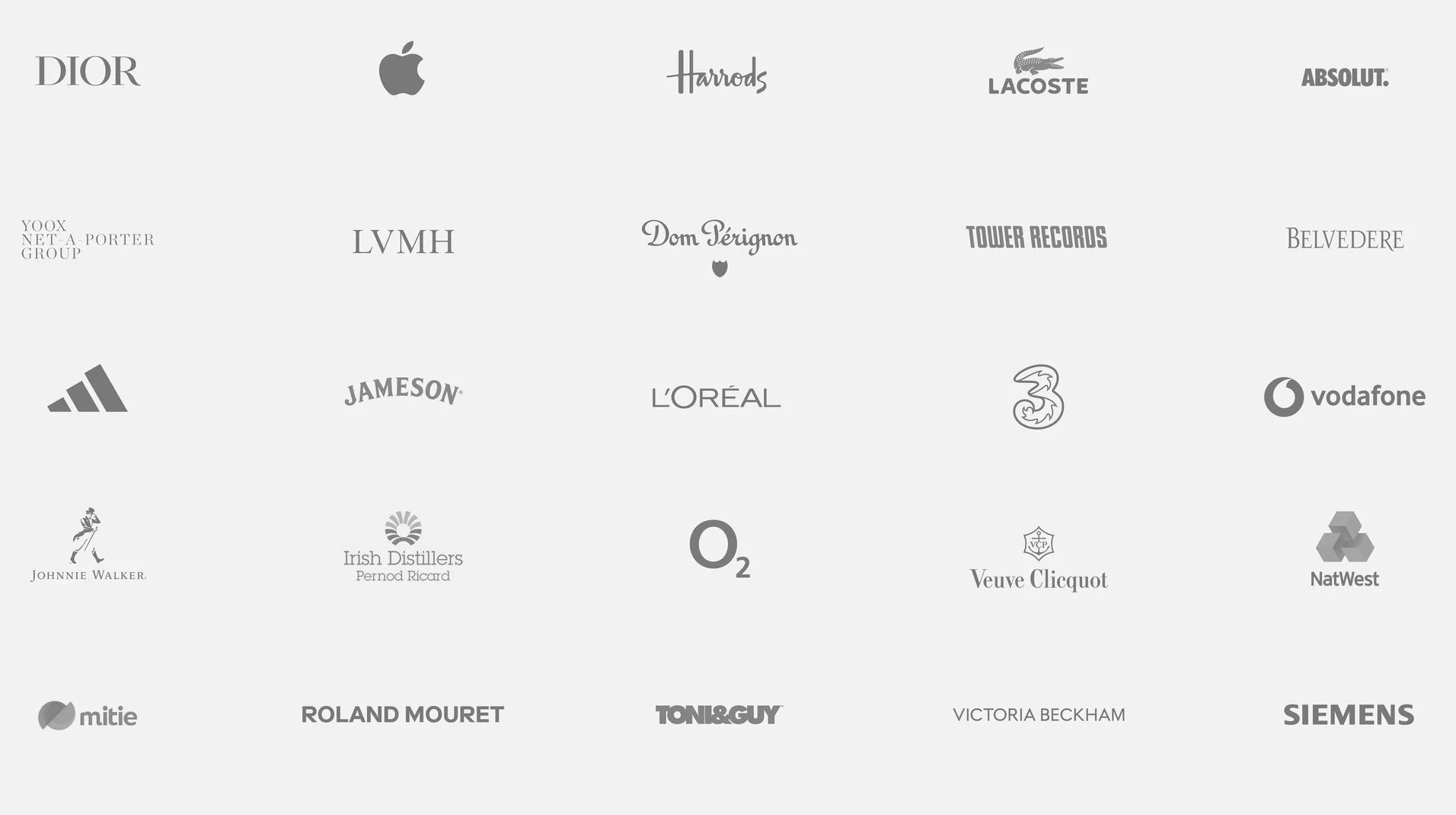 A collection of logos of various brands and companies arranged on a light gray background, including Dior, Apple, Harrods, Lacoste, Absolut, Yoox Net-A-Porter, LVMH, Dom Pérignon, Tower Records, Belvedere, Adidas, Jameson, L'Oréal, 3, Vodafone, Johnnie Walker, Irish Distillers Pernod Ricard, O2, Veuve Clicquot, NatWest, Mitie, Roland Mouret, Toni & Guy, Victoria Beckham, and Siemens.