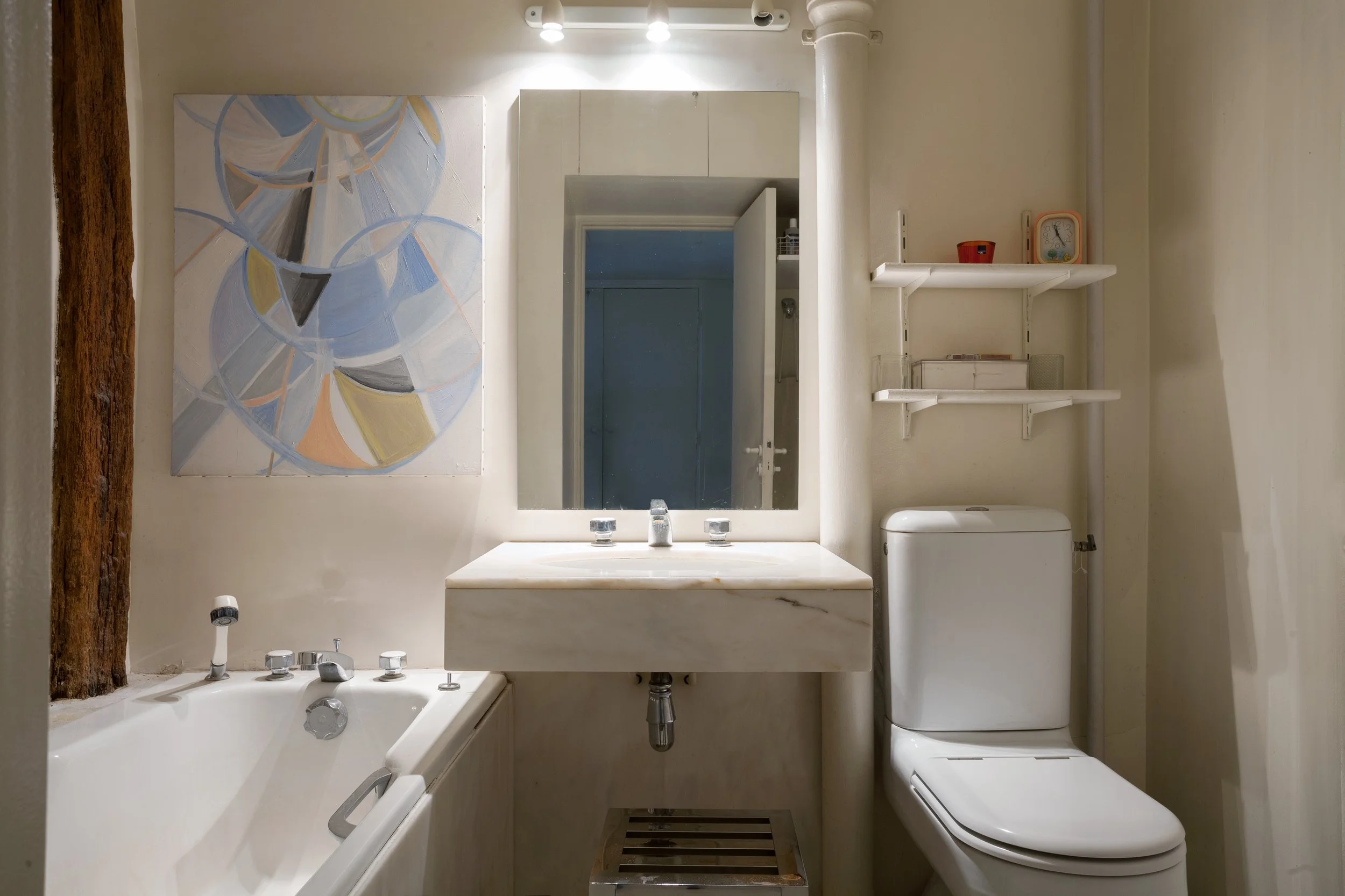 Salle de bain avec vasque en marbre d'un appartement dans le quartier Latin