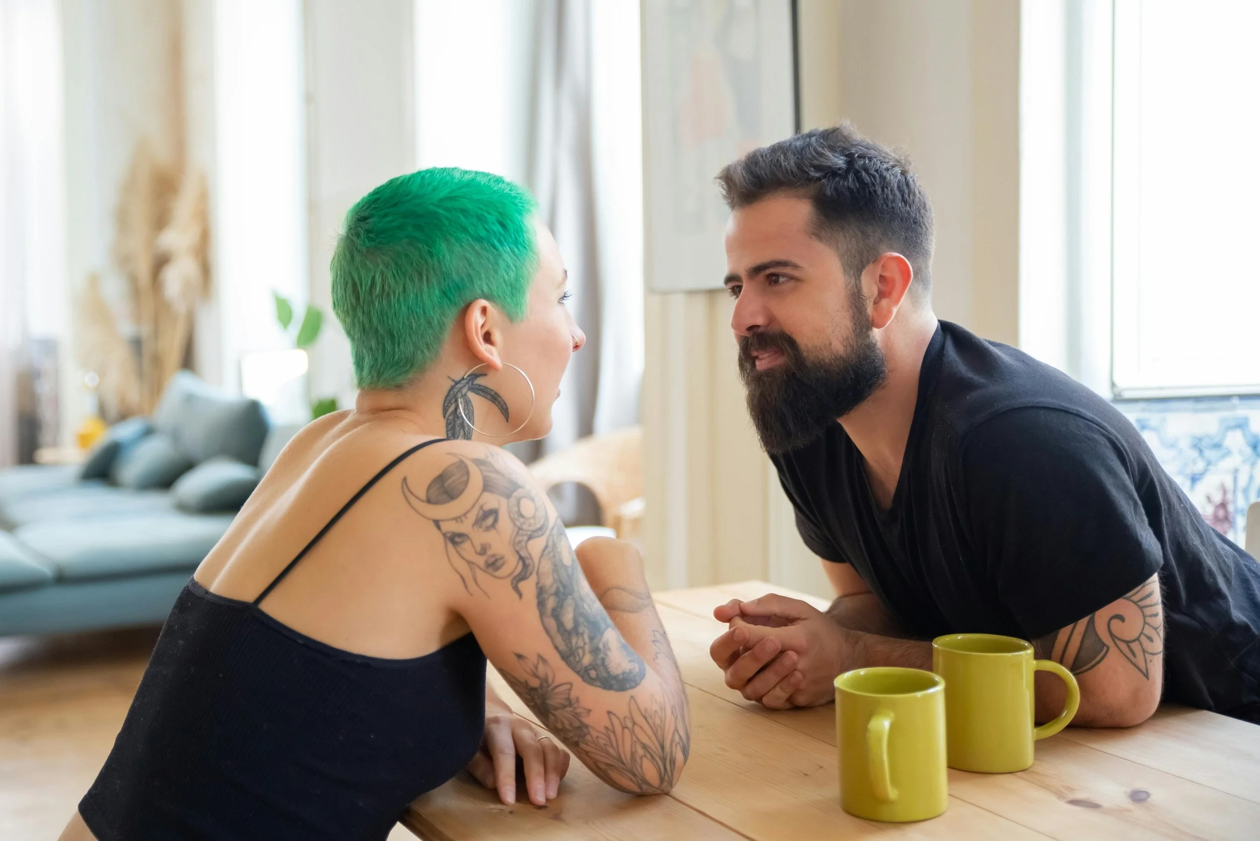 Couple in an unhurried conversation, leaning toward each other