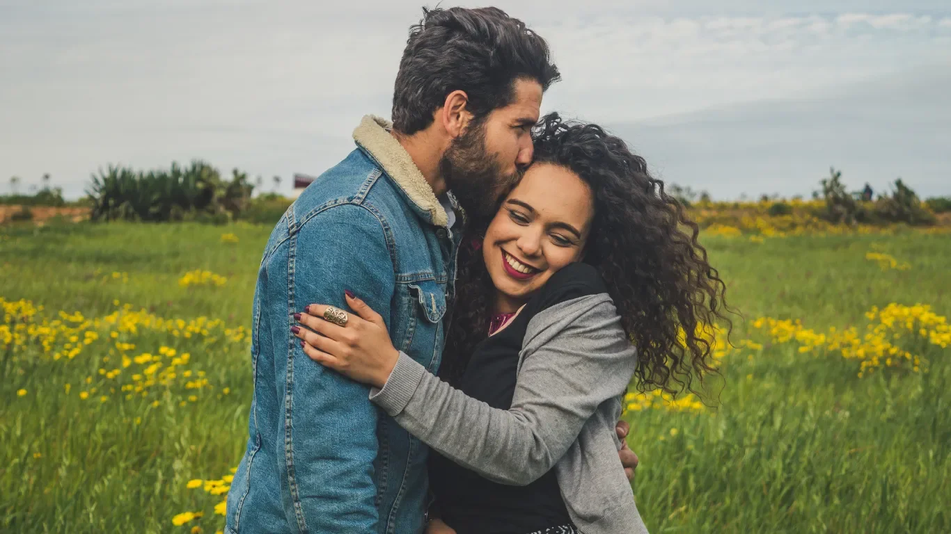 Couple hugging while having fun together on a date.