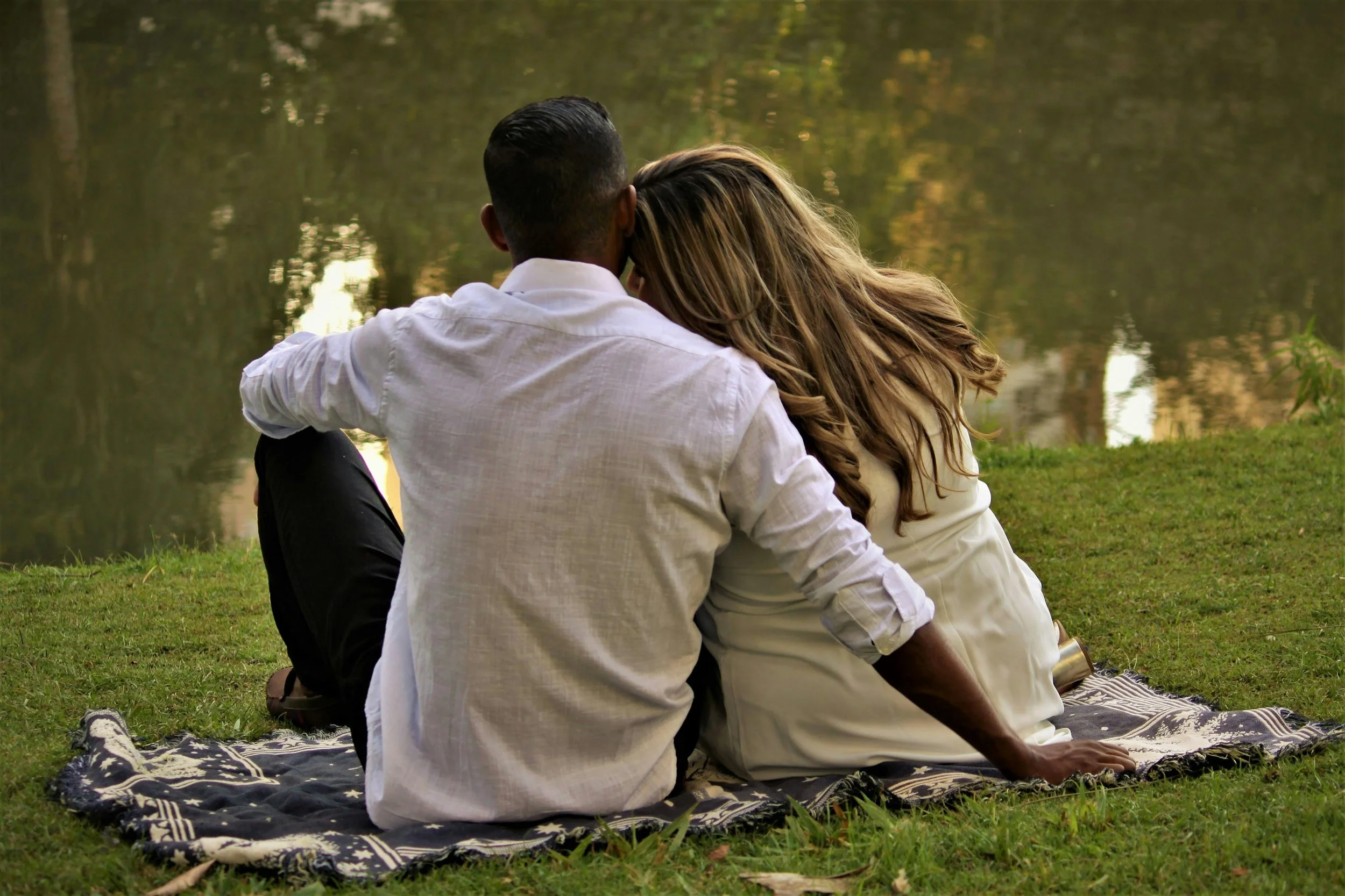 Couple sitting together outdoors, intimacy and connection therapy East Greenwich RI