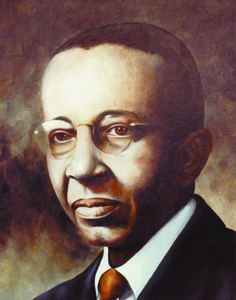 Portrait of Dr. Martin Luther King Jr. wearing glasses, a dark suit, white shirt, and a brown tie.