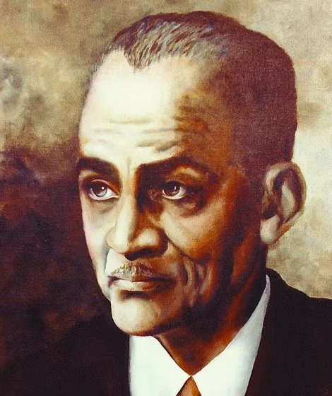 A painted portrait of a man with slicked-back hair, light skin, and a mustache, wearing a black suit and white shirt.