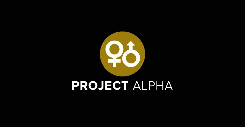 Logo featuring gender symbols for female and male inside a gold circle, with the text 'PROJECT ALPHA' beneath it on a black background.