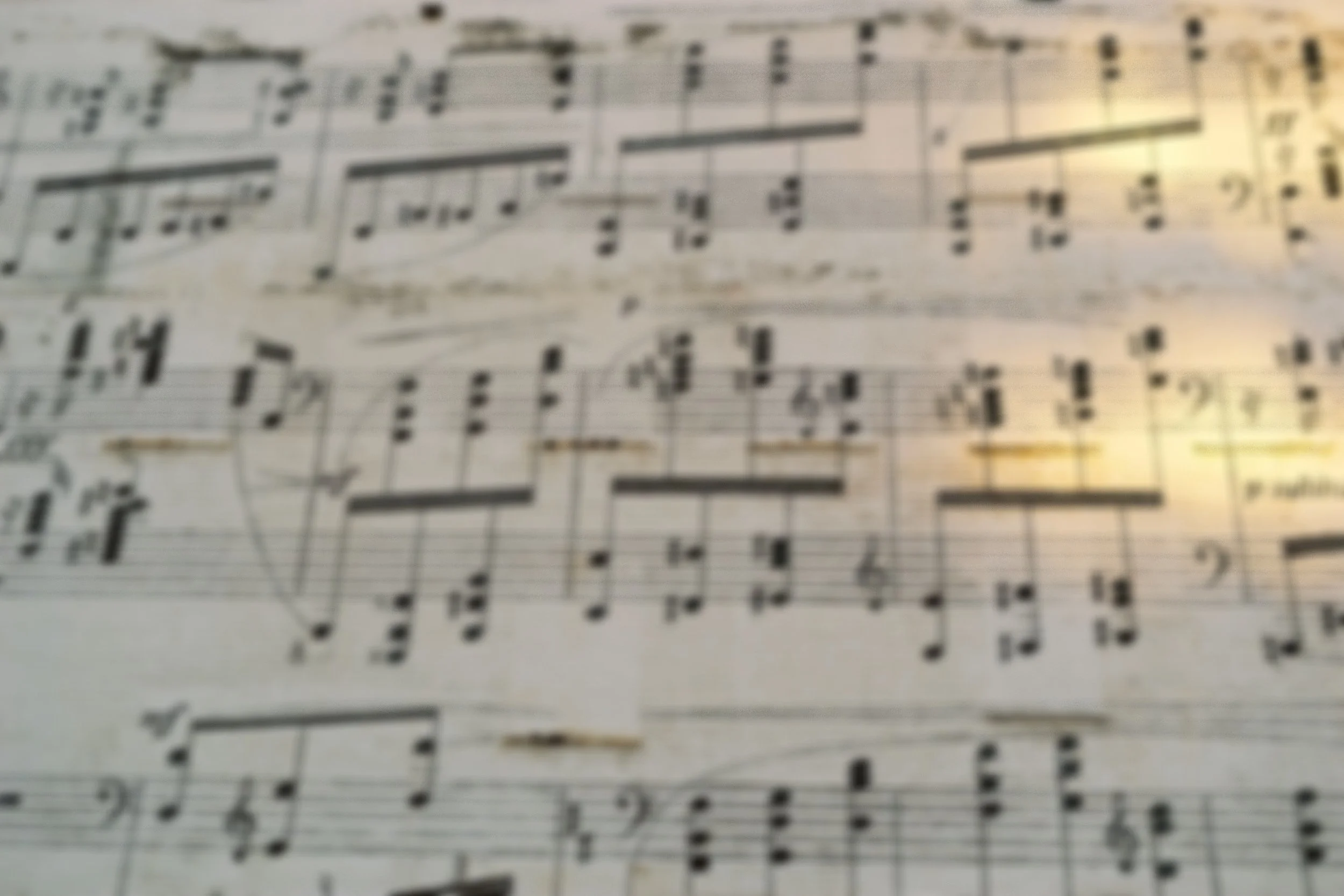Close-up photo of sheet music with musical notes and staff lines.
