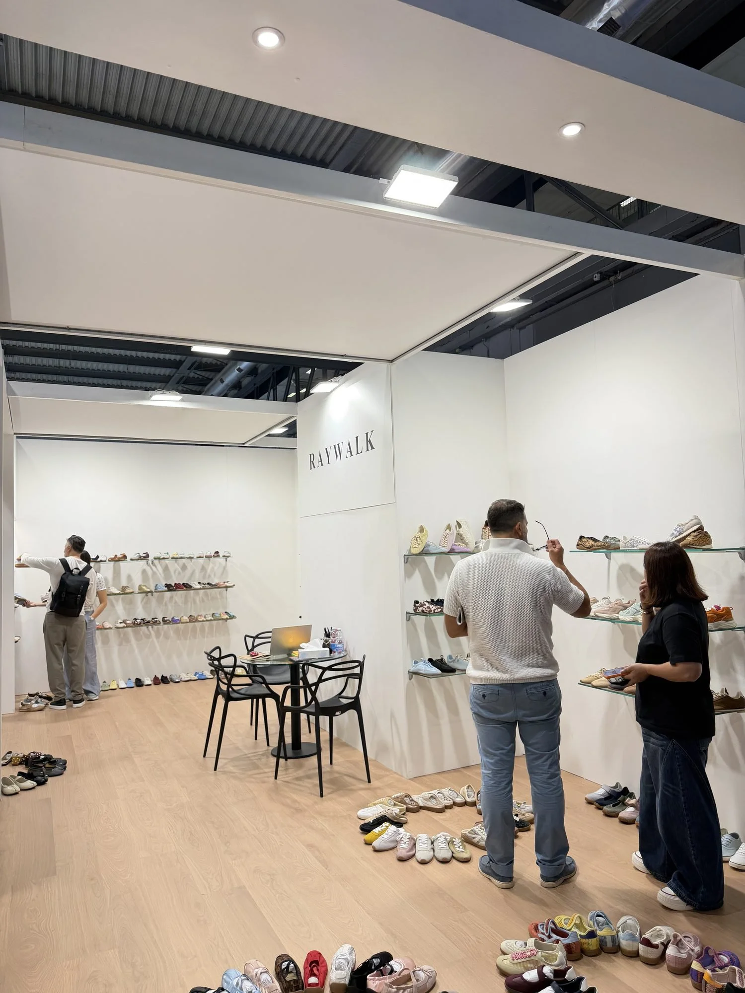 Buyers reviewing samples at the Raywalk booth, MICAM Milano 2026