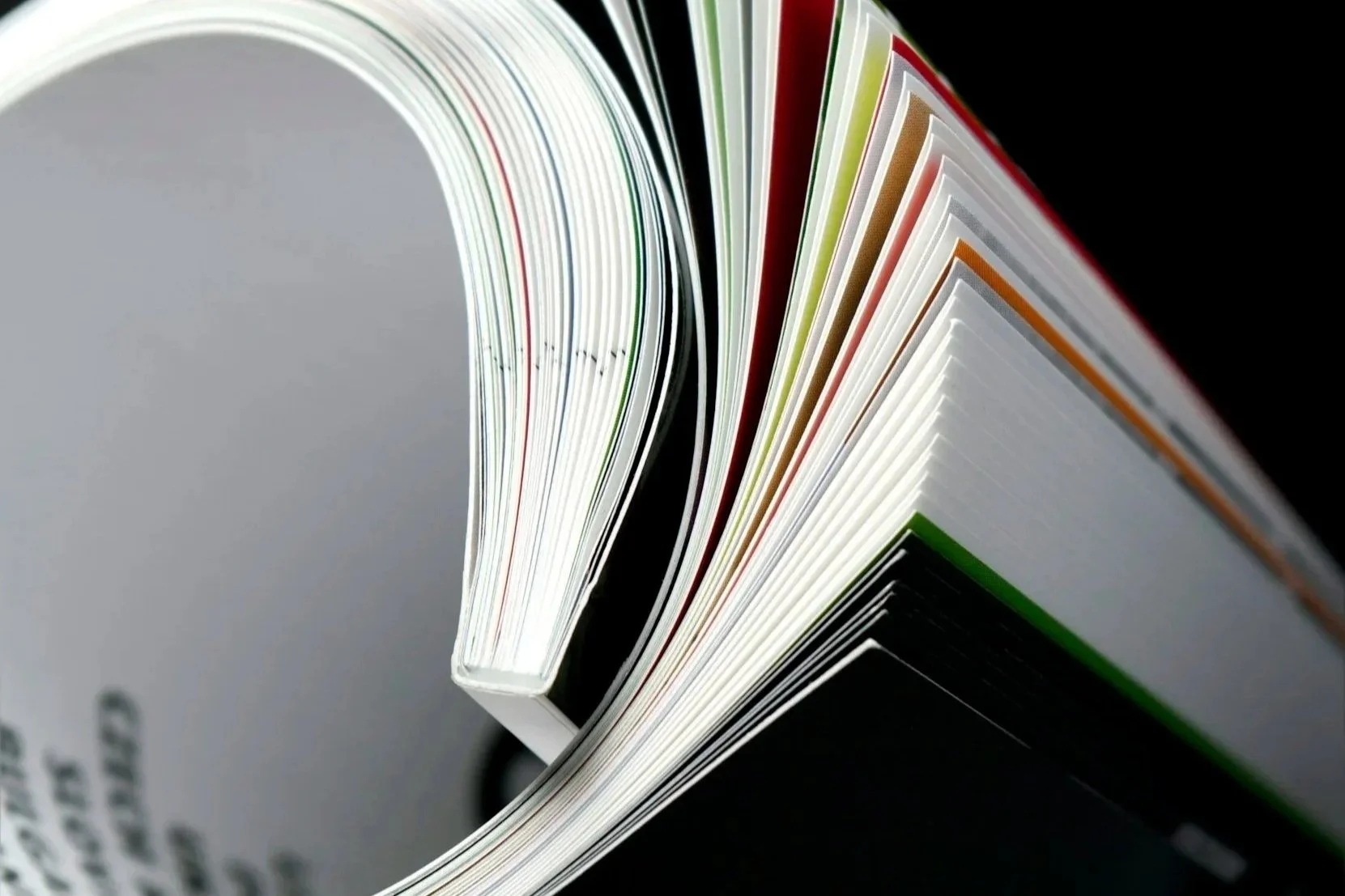 Close-up of a spiral-bound book with colorful pages