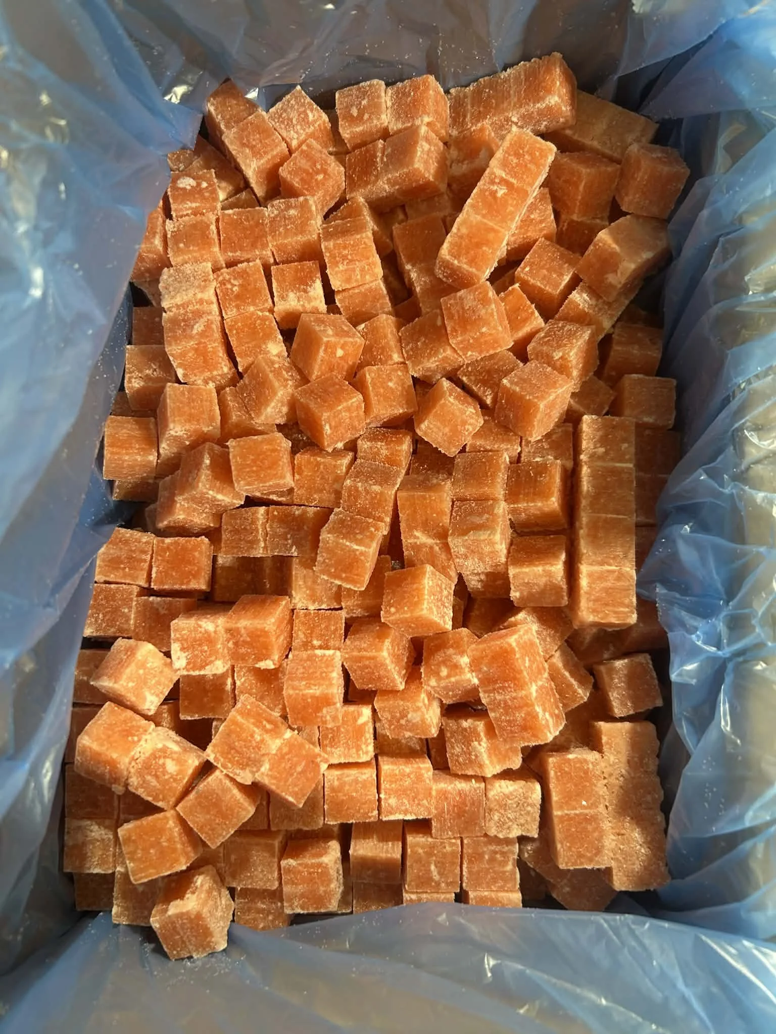 Frozen diced salmon in a plastic bag.