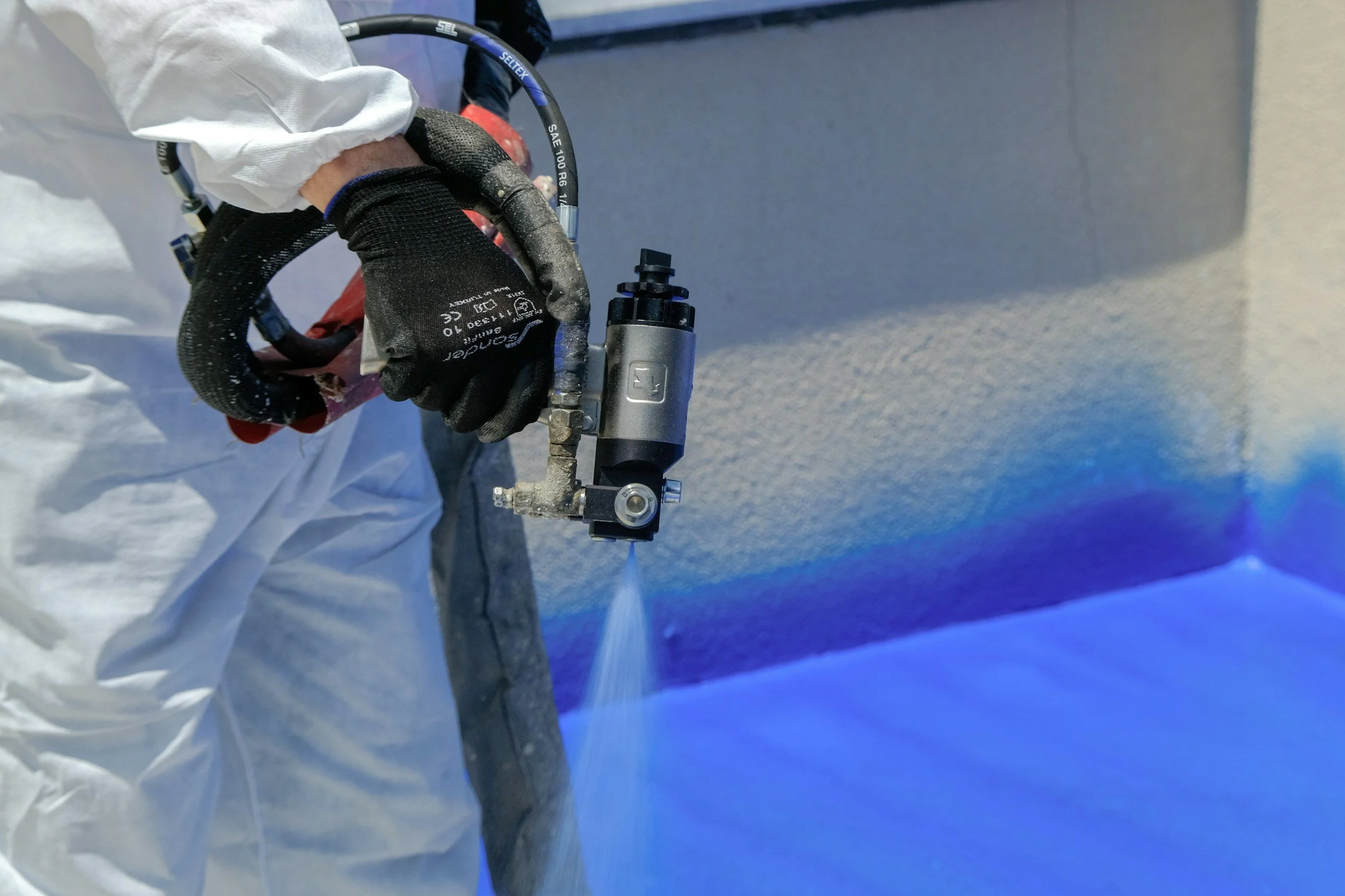 Representative photograph of industrial spray coating; not Northline Industrial property or operations.