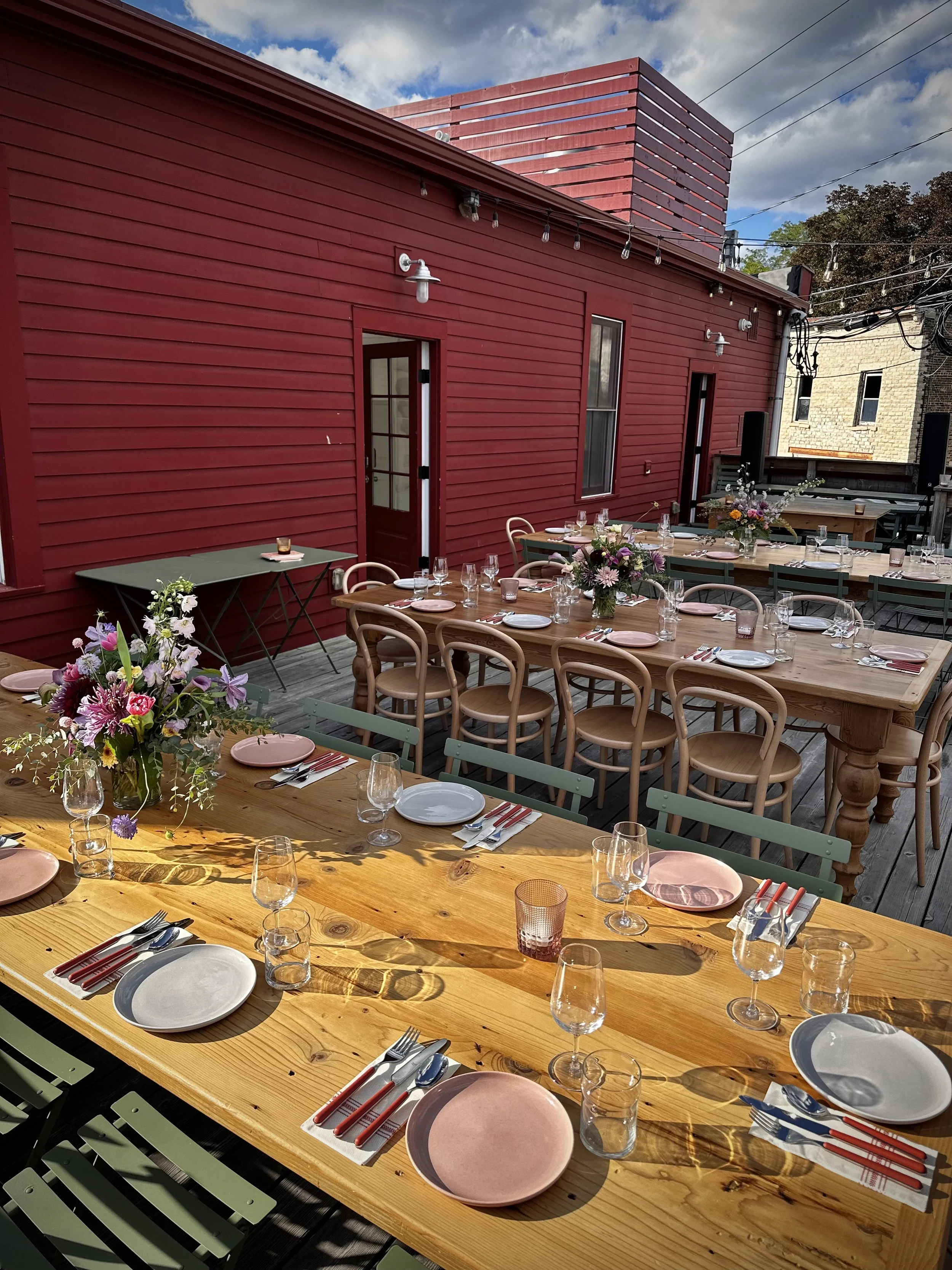 Group dining and private event setup on the outdoor deck at Mr. Cat Brasserie in Hudson NY