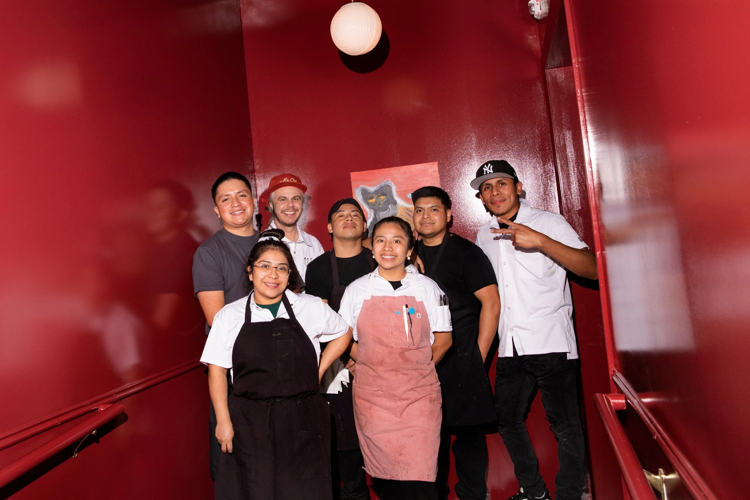 Kitchen team preparing French brasserie dishes at Mr. Cat Brasserie