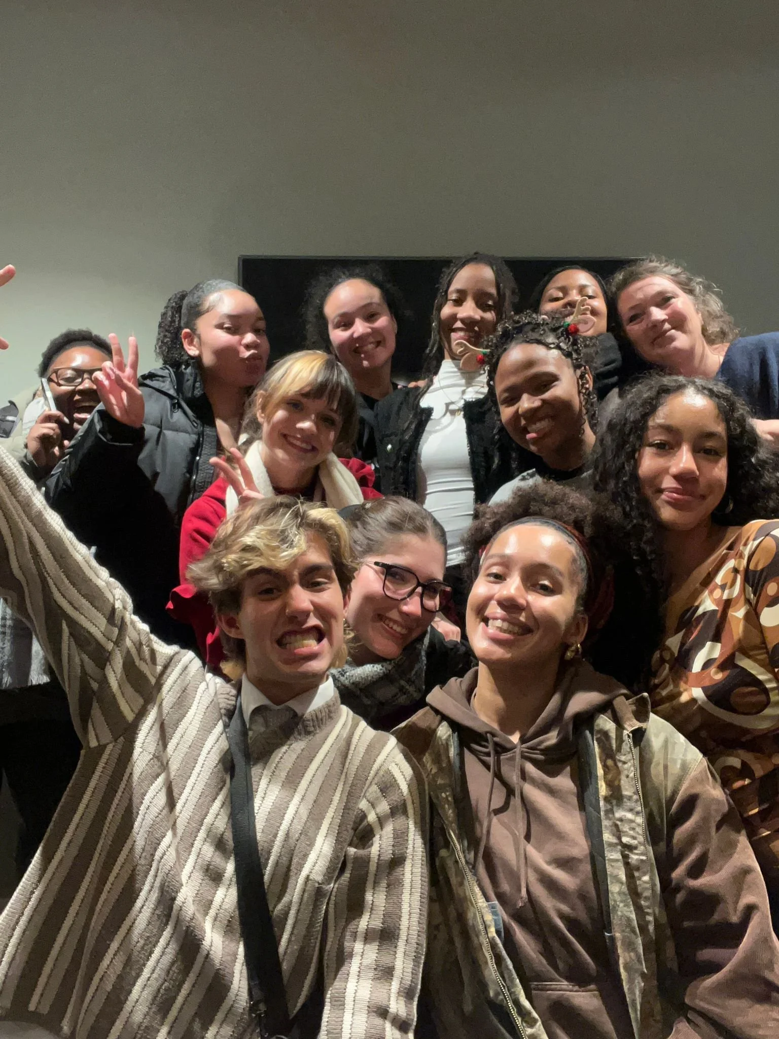 Group of people smiling and posing for a photo together indoors.