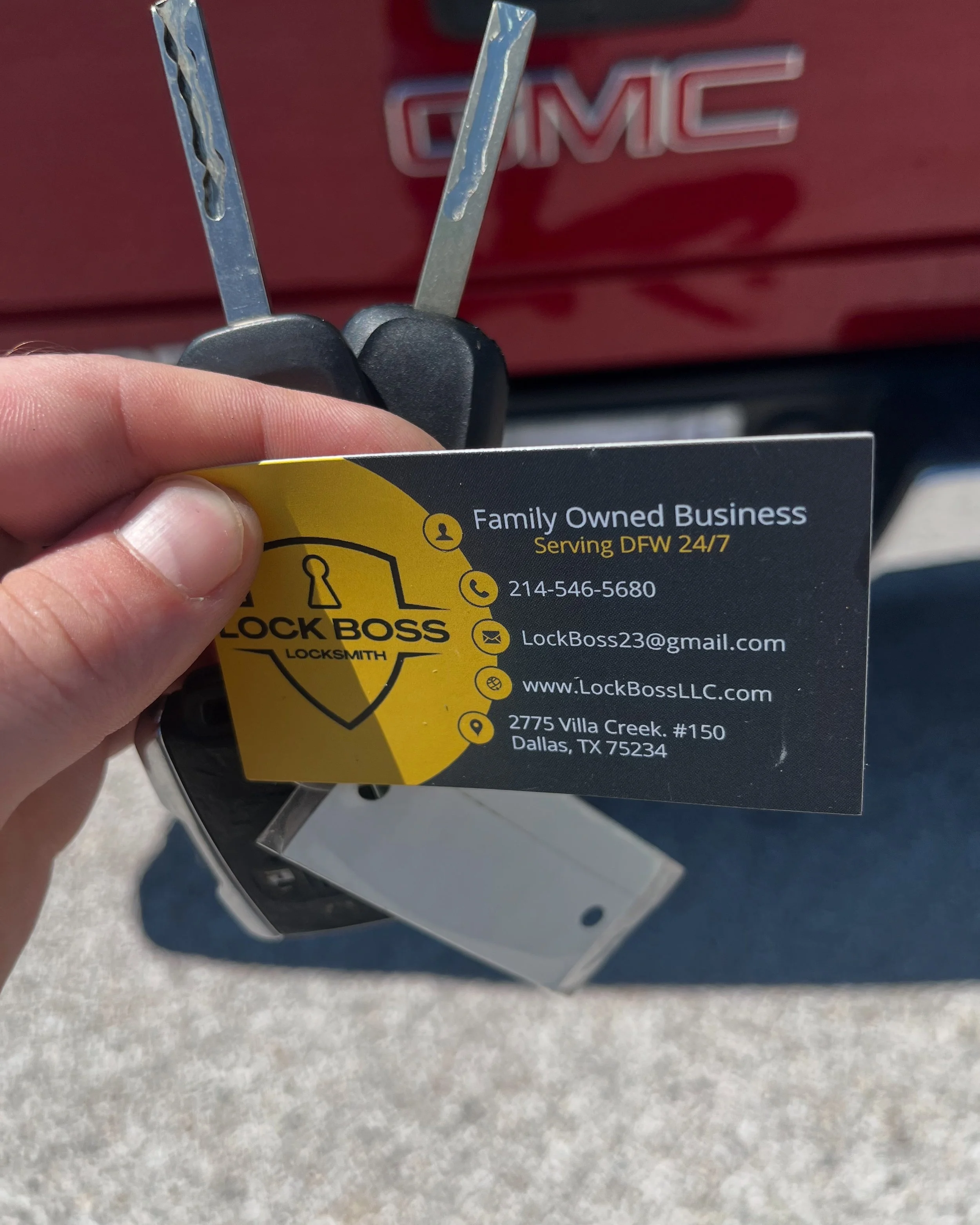Business card for a locksmith company called Lock Boss showing contact information and a set of car keys.