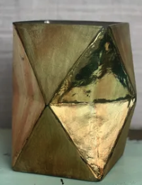 A geometric metallic votive or vase decor rental