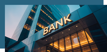 Exterior of a modern bank building with large glass windows and a prominent 'BANK' sign.