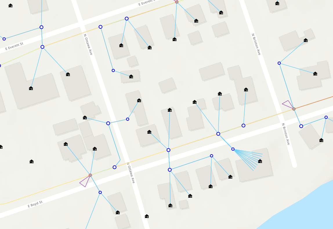 A map showing the layout of a neighborhood with streets, houses, and a network of signals or connections, possibly illustrating utility or communication lines.