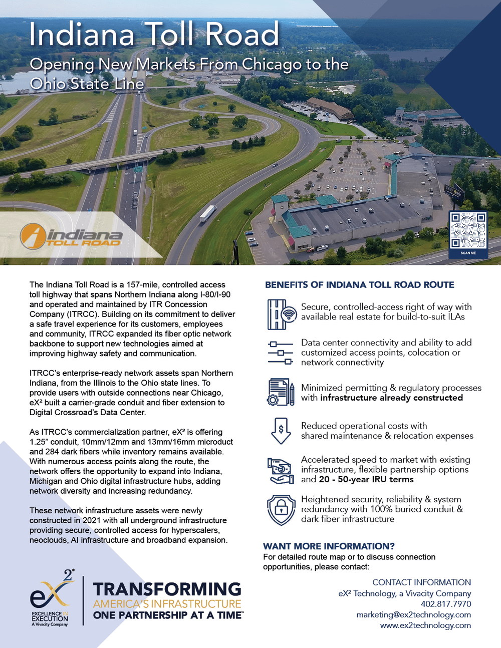 Aerial view of Indiana Toll Road and surrounding area, including highway interchanges, a shopping plaza, green spaces, and water bodies.