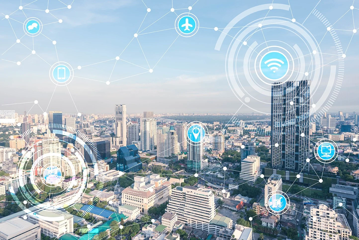 A city skyline overlaid with icons representing technology, communication, transportation, and connectivity, including a Wi-Fi symbol at the center.