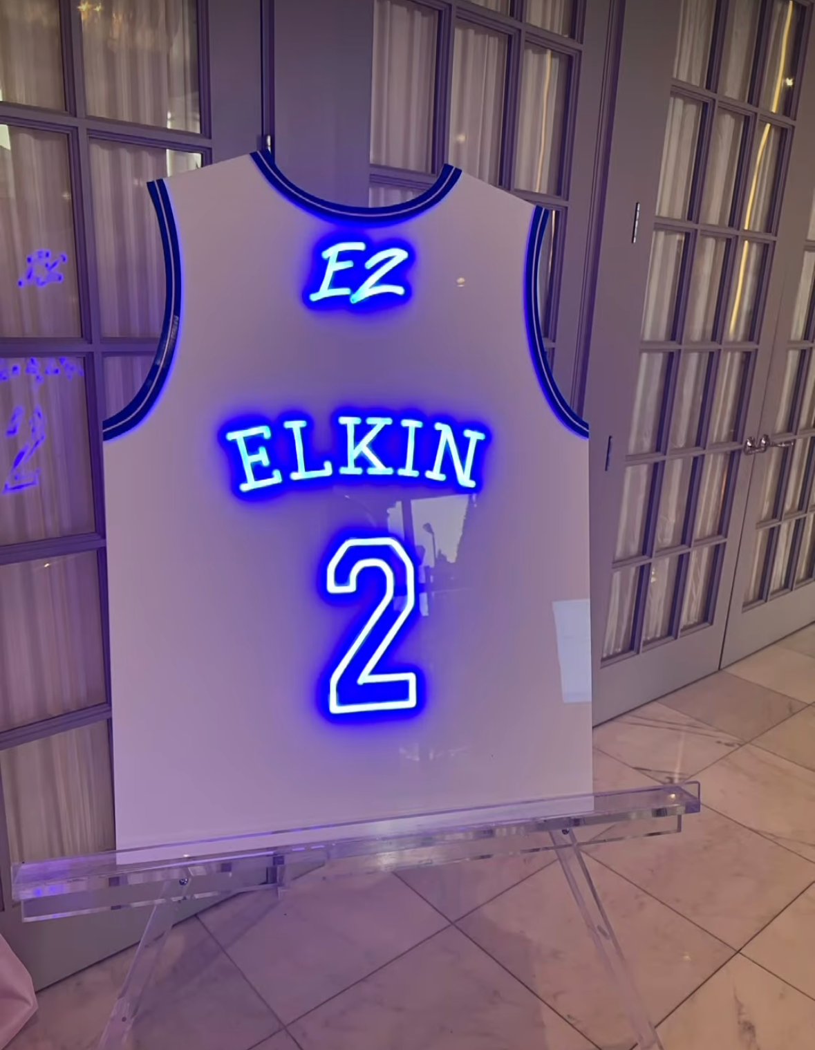 Custom white basketball jersey with blue neon. 