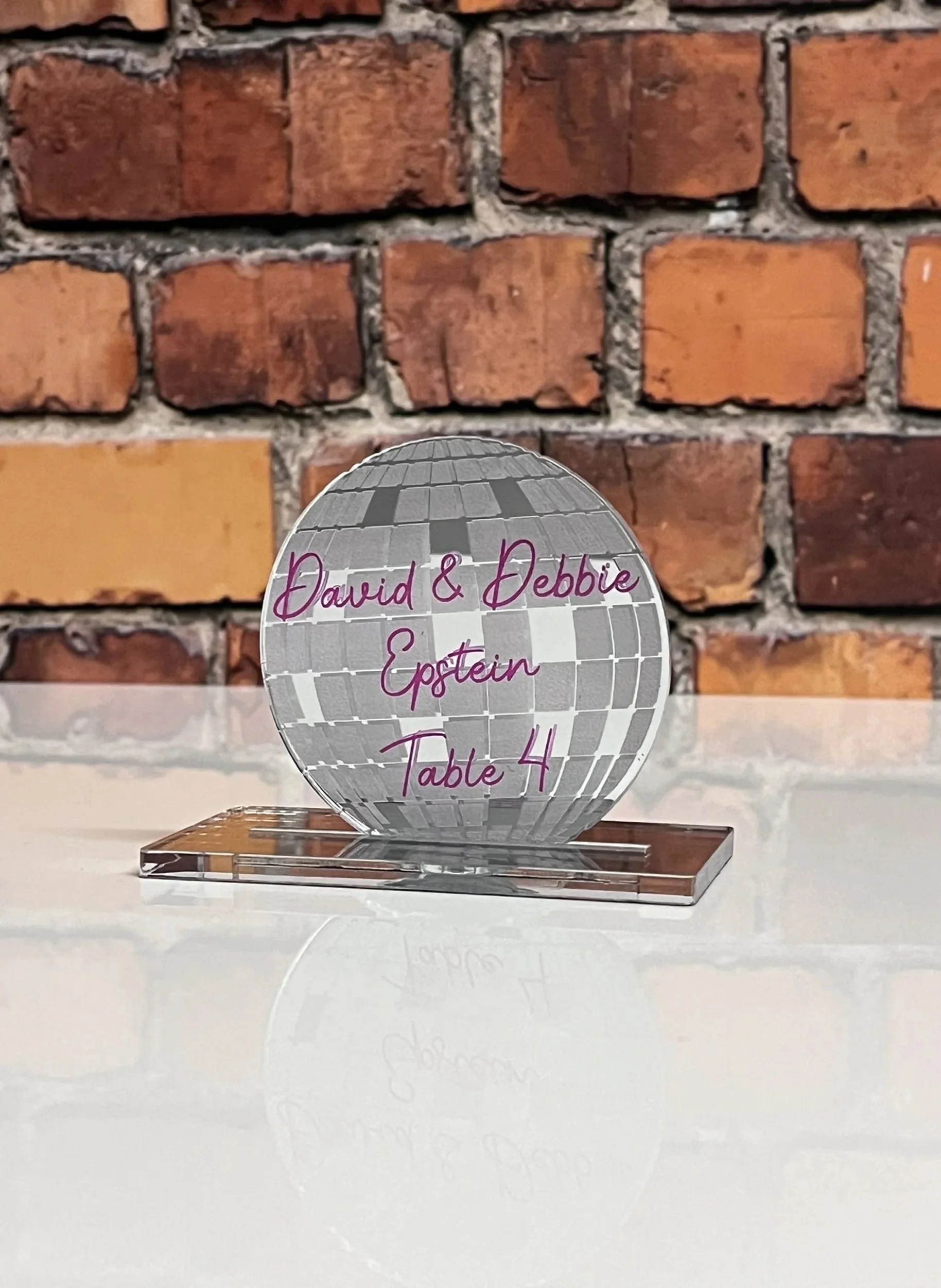 Custom silver mirror disco ball escort card. 