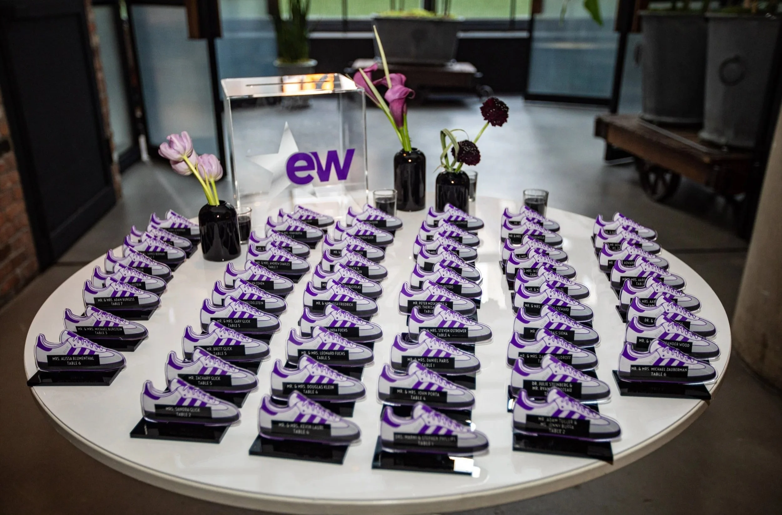 Purple and white Nike sneaker escort cards. 