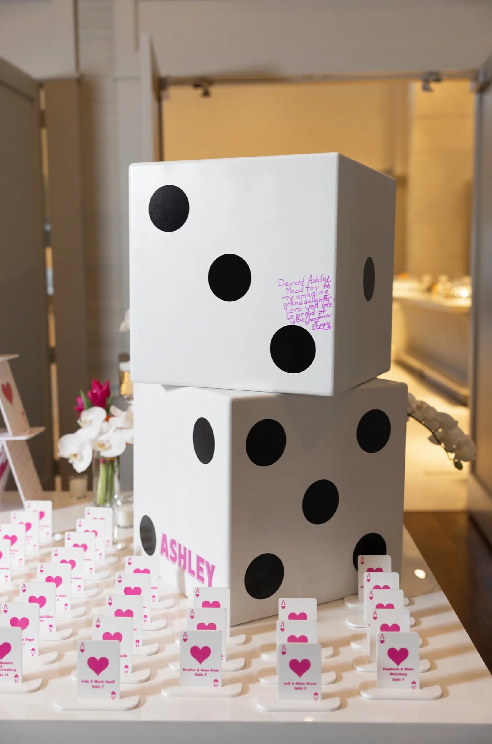 White and pink playing cards escort cards. 