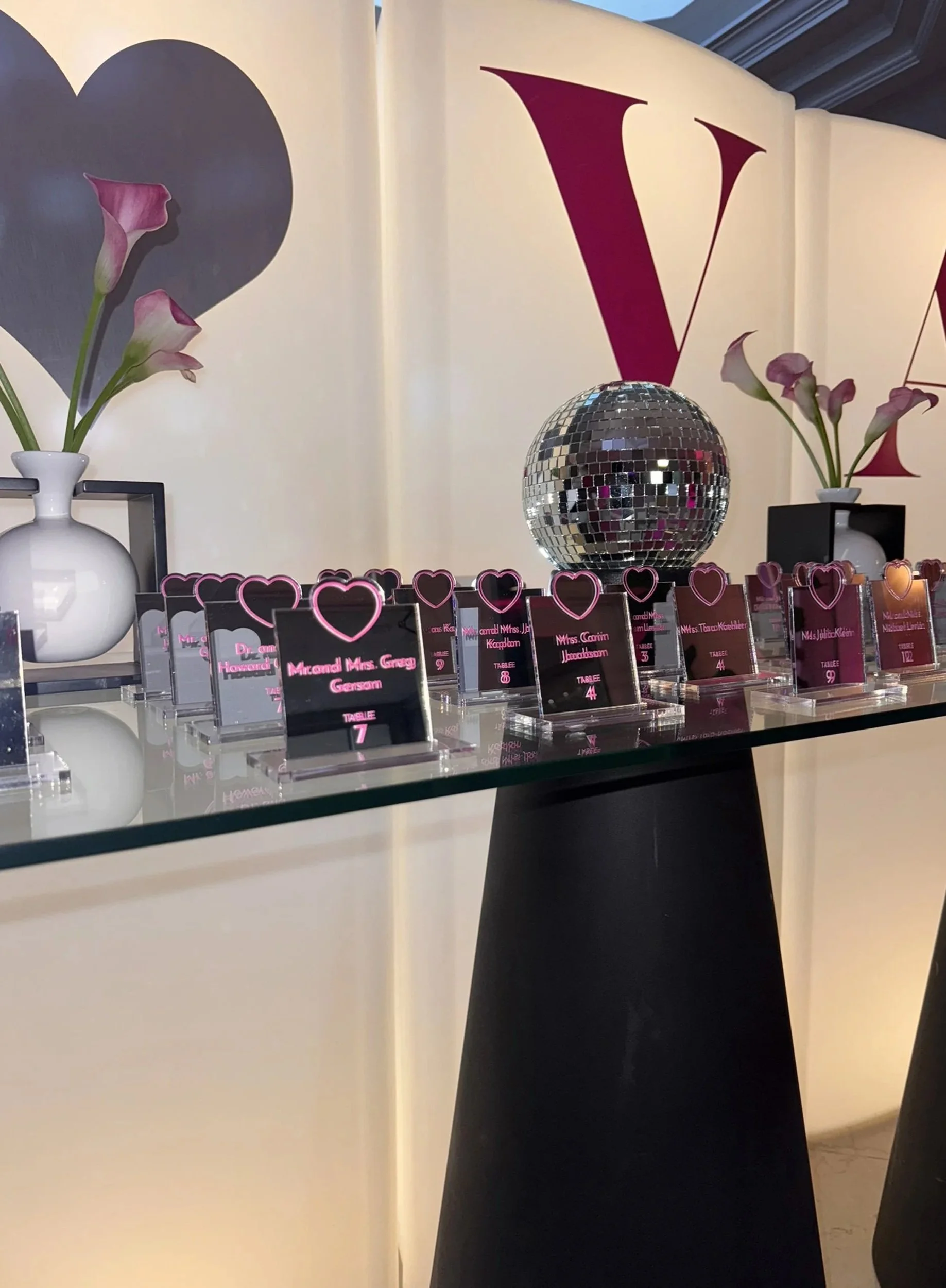 Mirrored acrylic escort cards with a heart. 