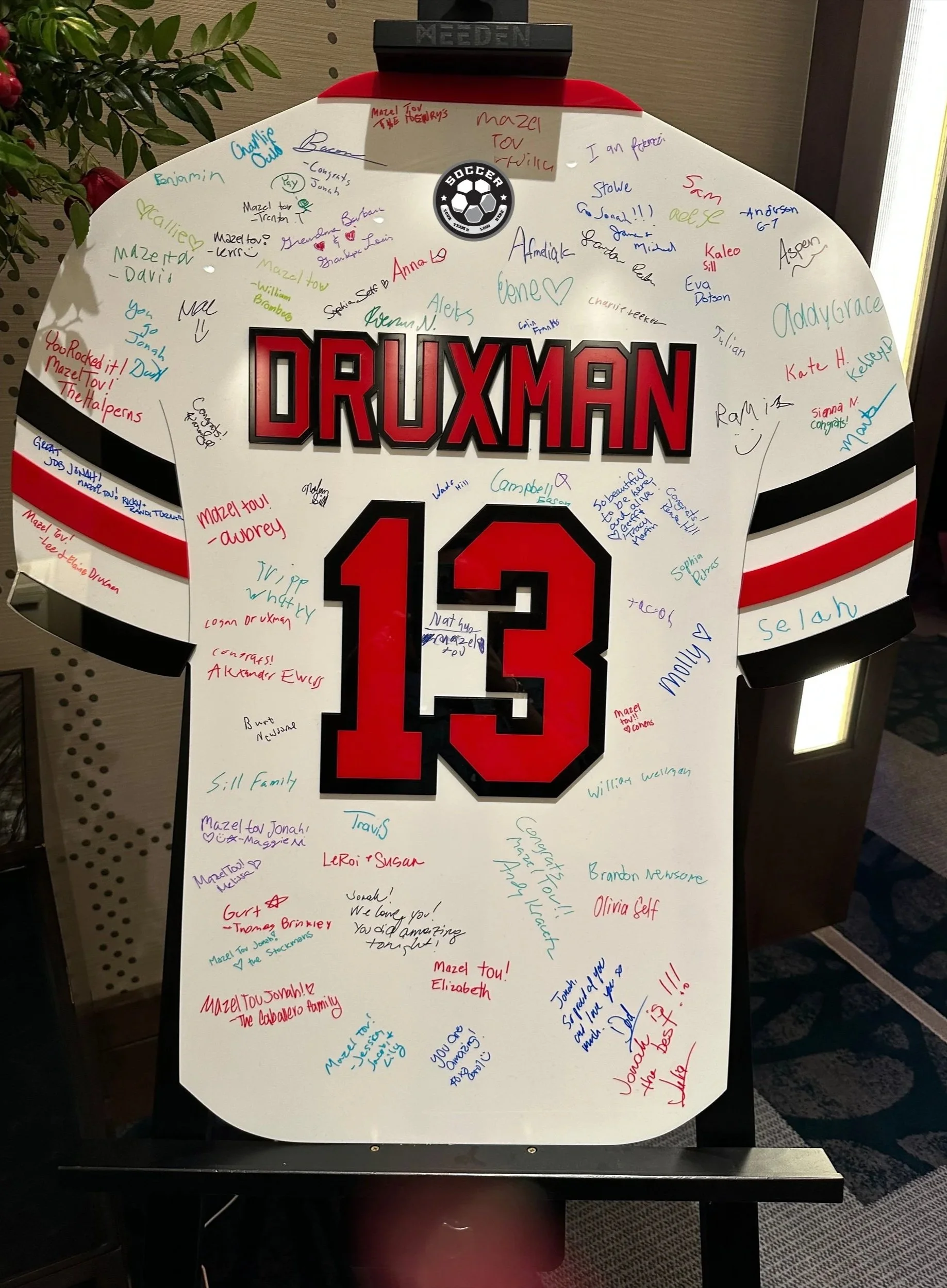 Custom soccer jersey sign-in board with red and black accents